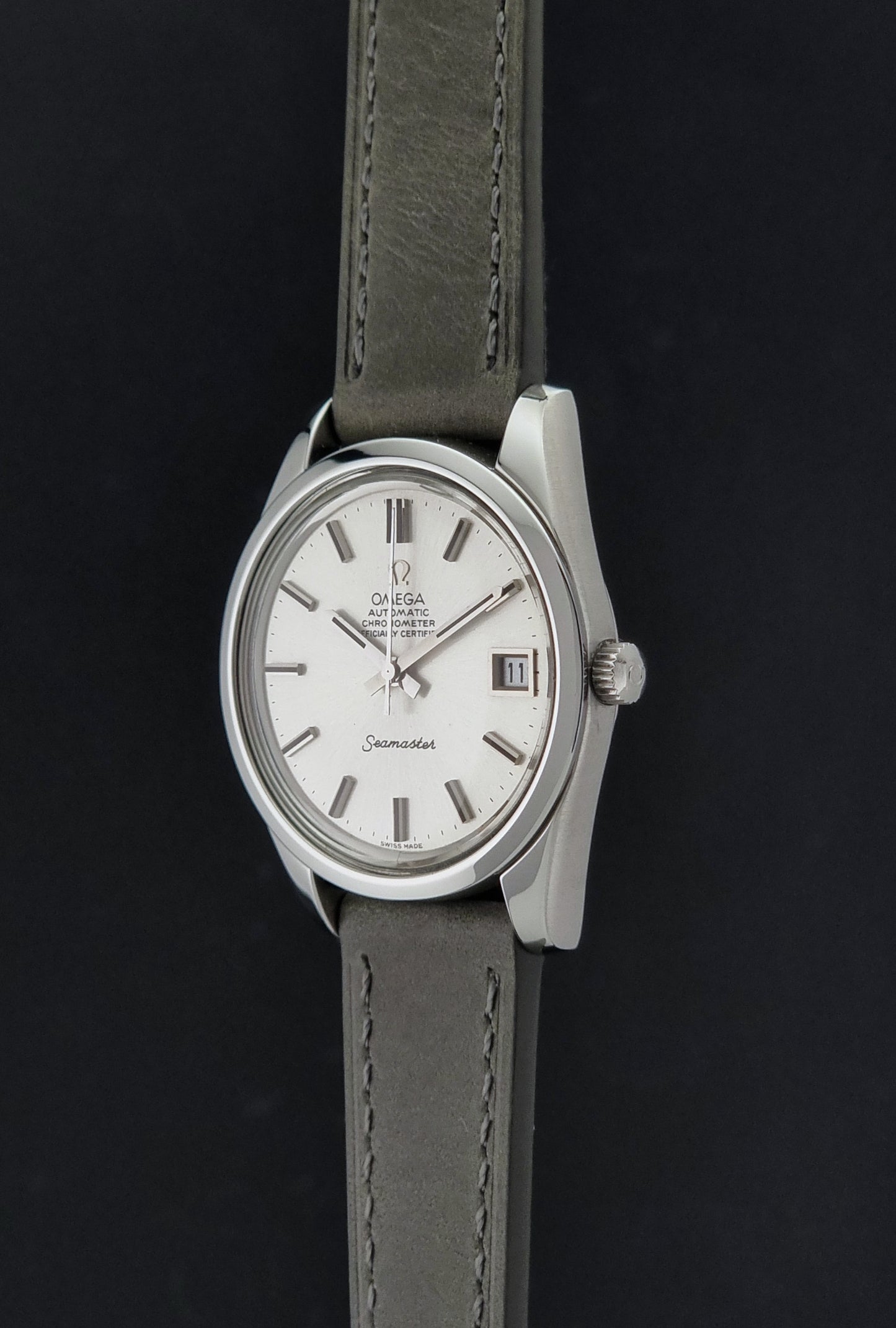 Vintage Omega Seamaster 168.0061/166.0172 watch on a grey strap and dark back ground crown profile view