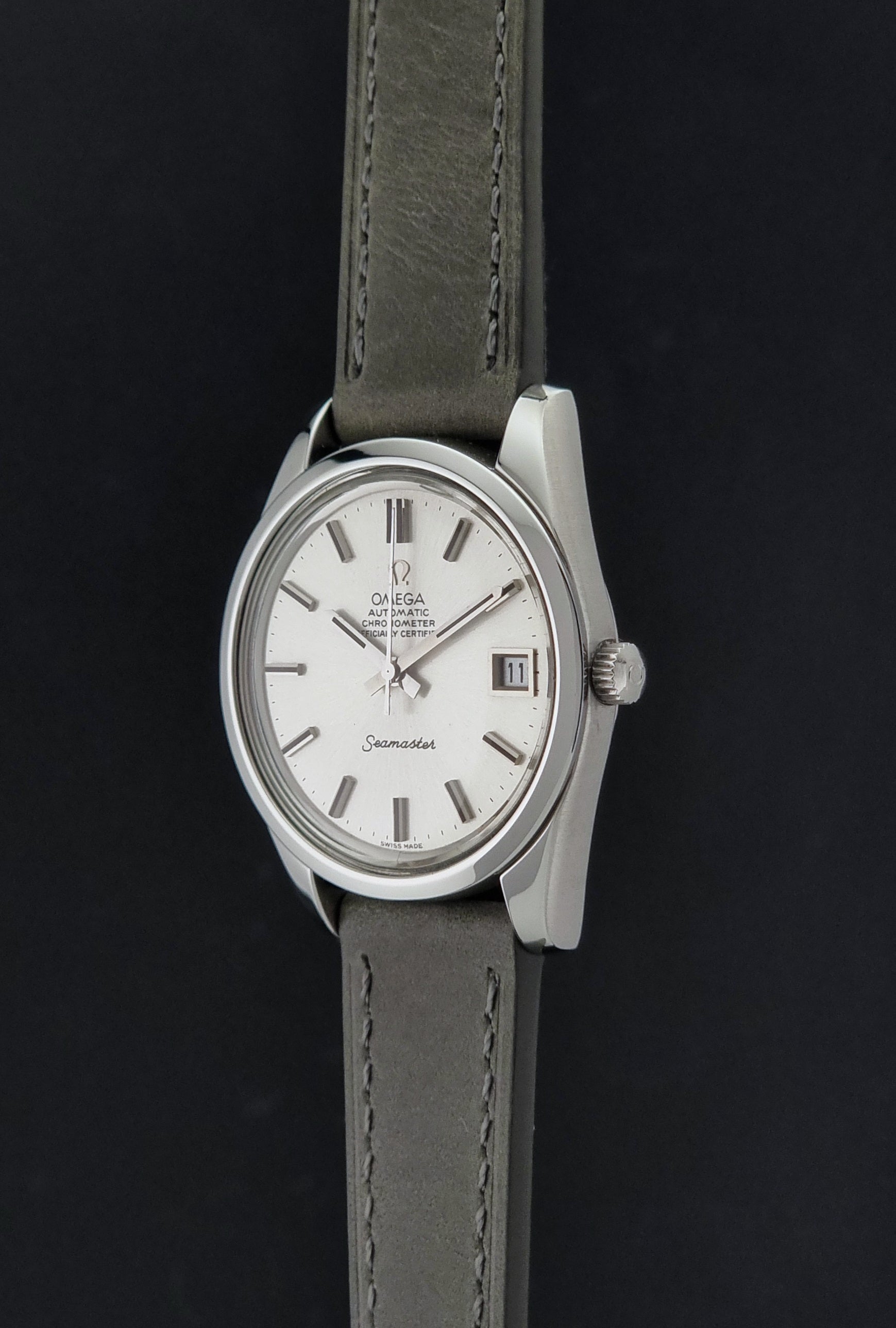Vintage Omega Seamaster 168.0061/166.0172 watch on a grey strap and dark back ground crown profile view