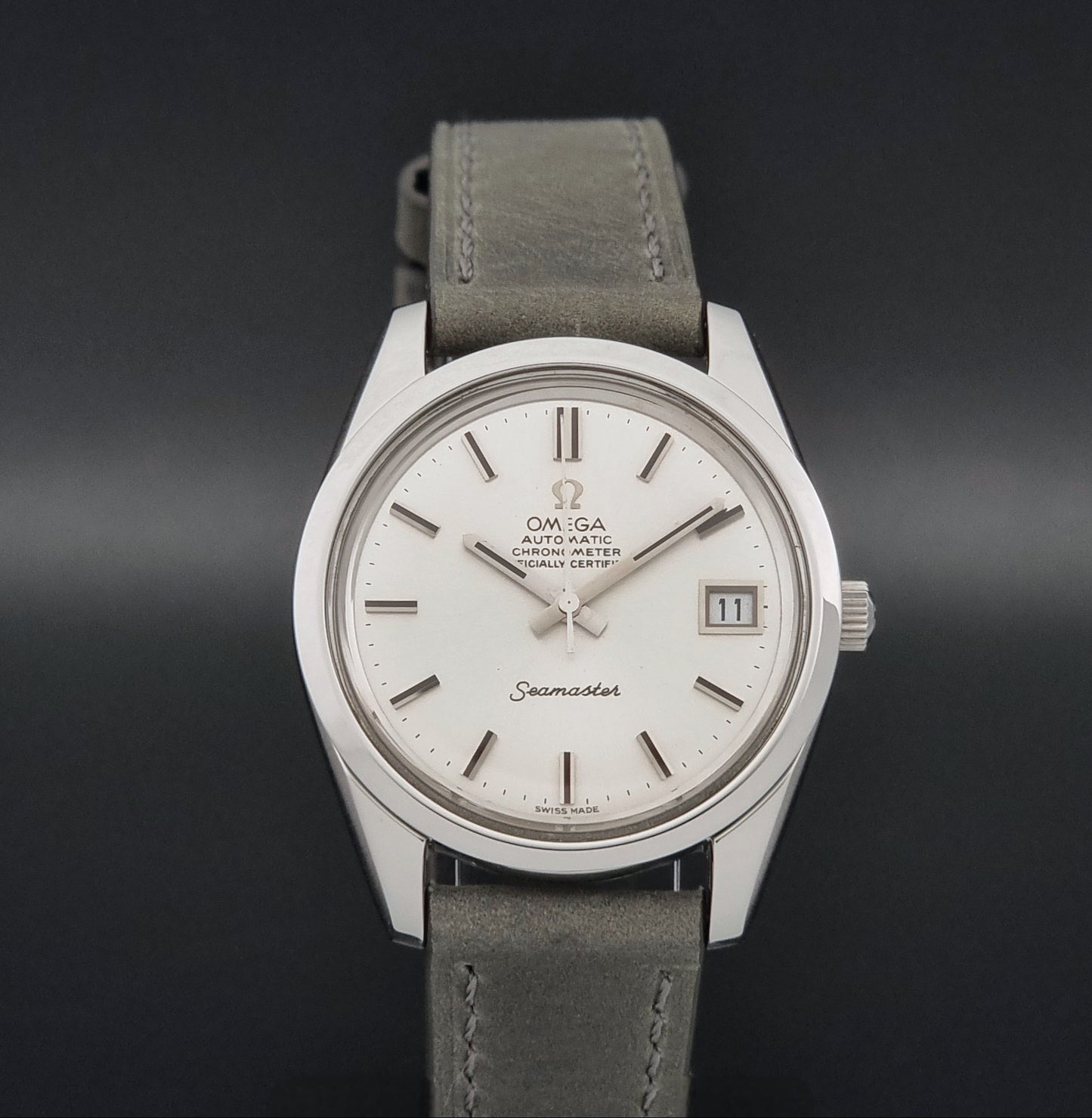 Vintage Omega Seamaster 168.0061/166.0172 watch on a grey strap and dark back ground close dial view