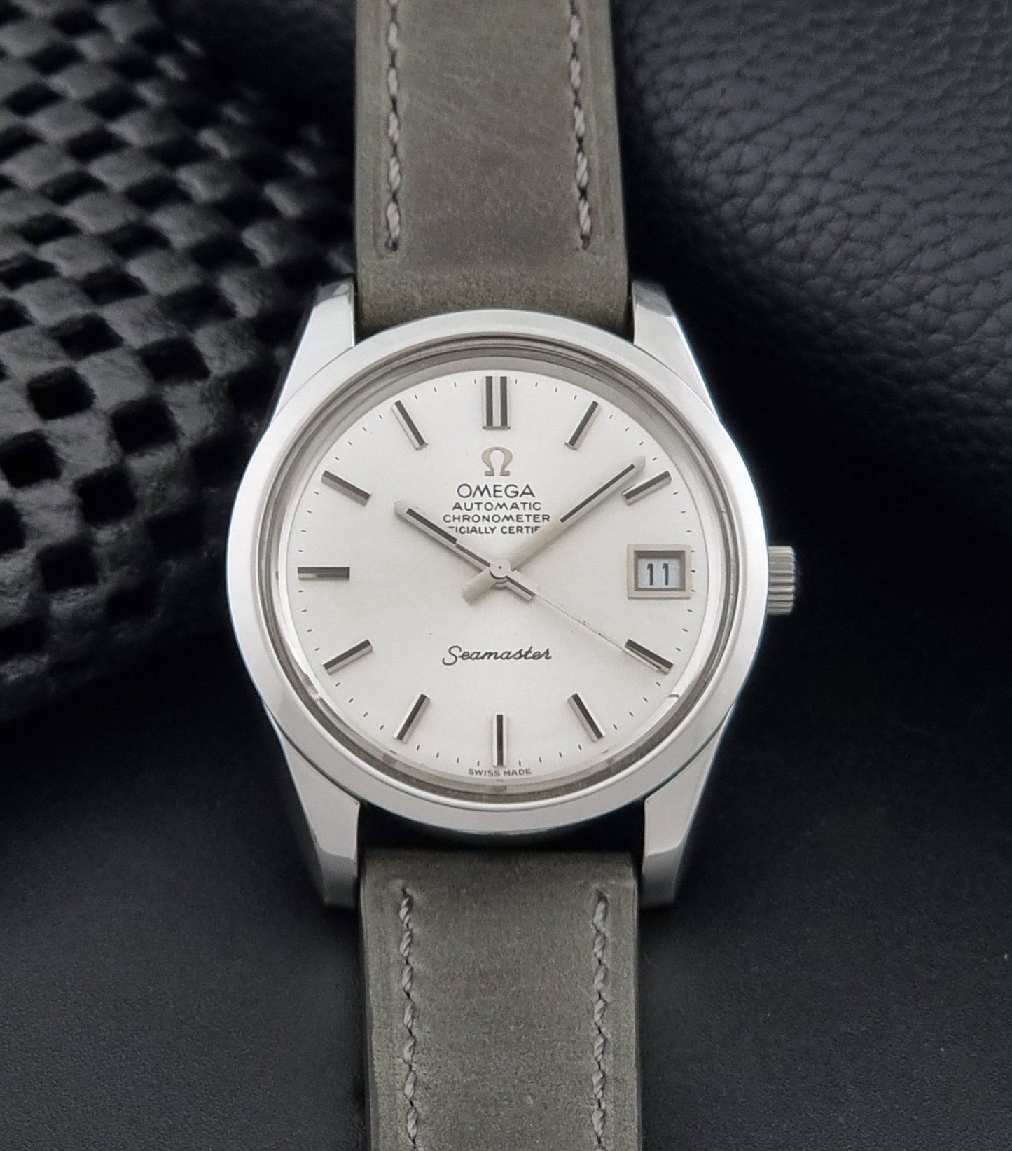 Vintage Omega Seamaster 168.0061/166.0172 watch on a grey strap and dark back ground dial view