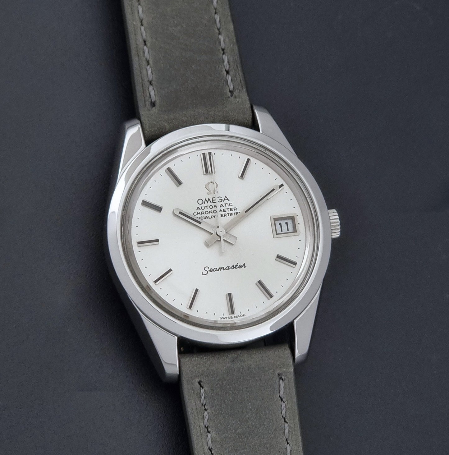 Vintage Omega Seamaster 168.0061/166.0172 watch on a grey strap and dark back ground front view