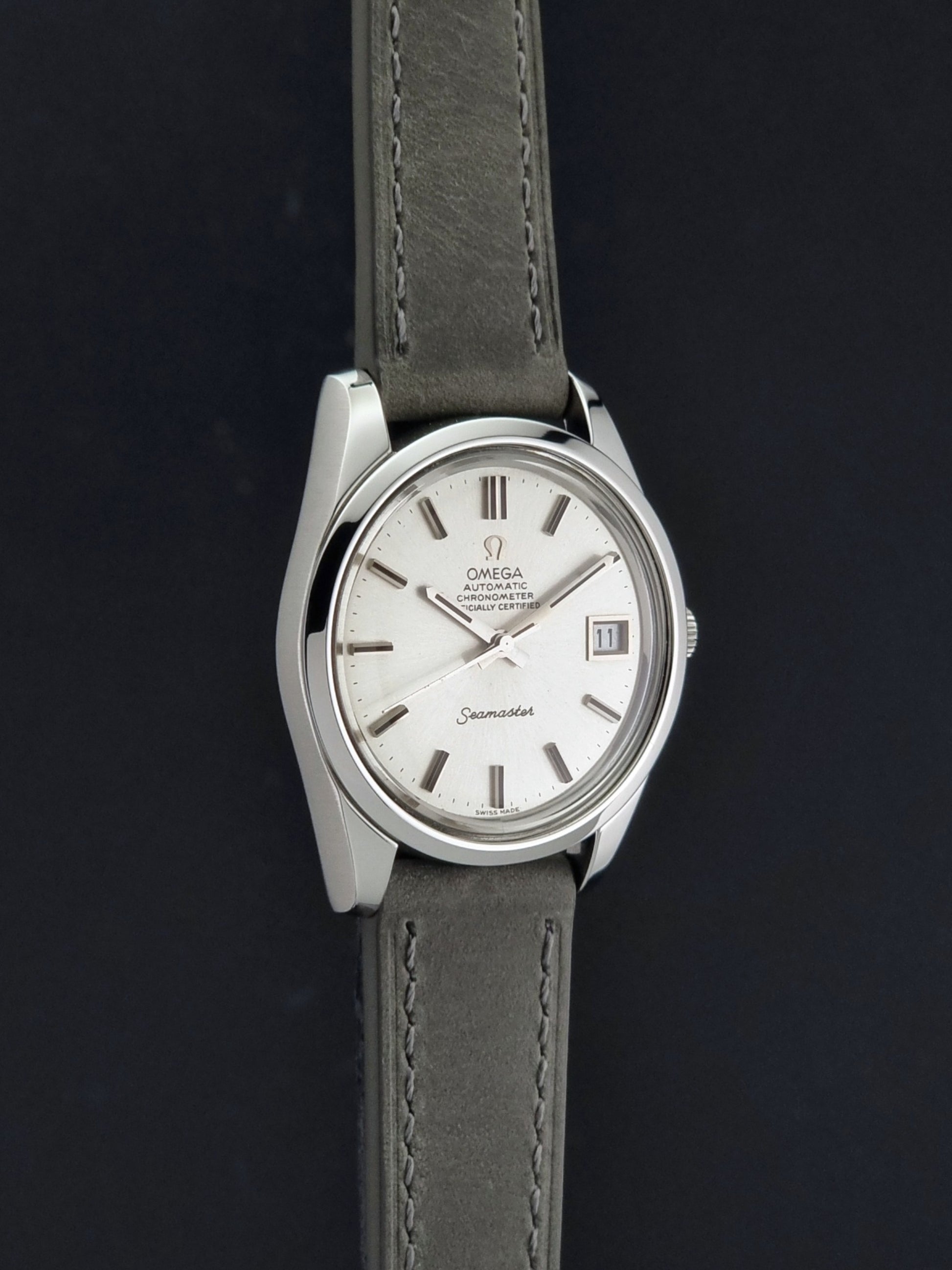 Vintage Omega Seamaster 168.0061/166.0172 watch on a grey strap and dark back ground side profile view