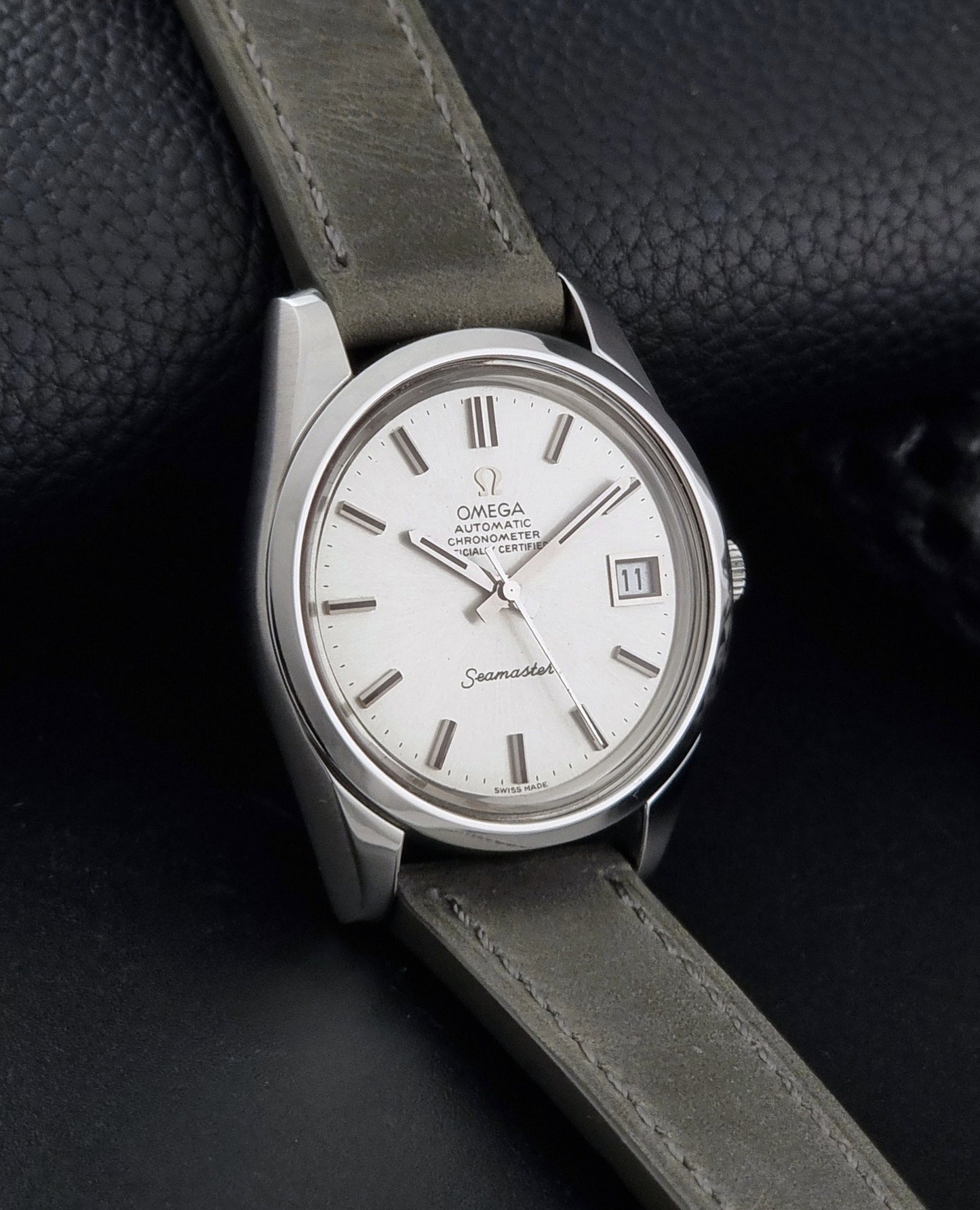 Vintage Omega Seamaster 168.0061/166.0172 watch on a grey strap and dark back ground side view