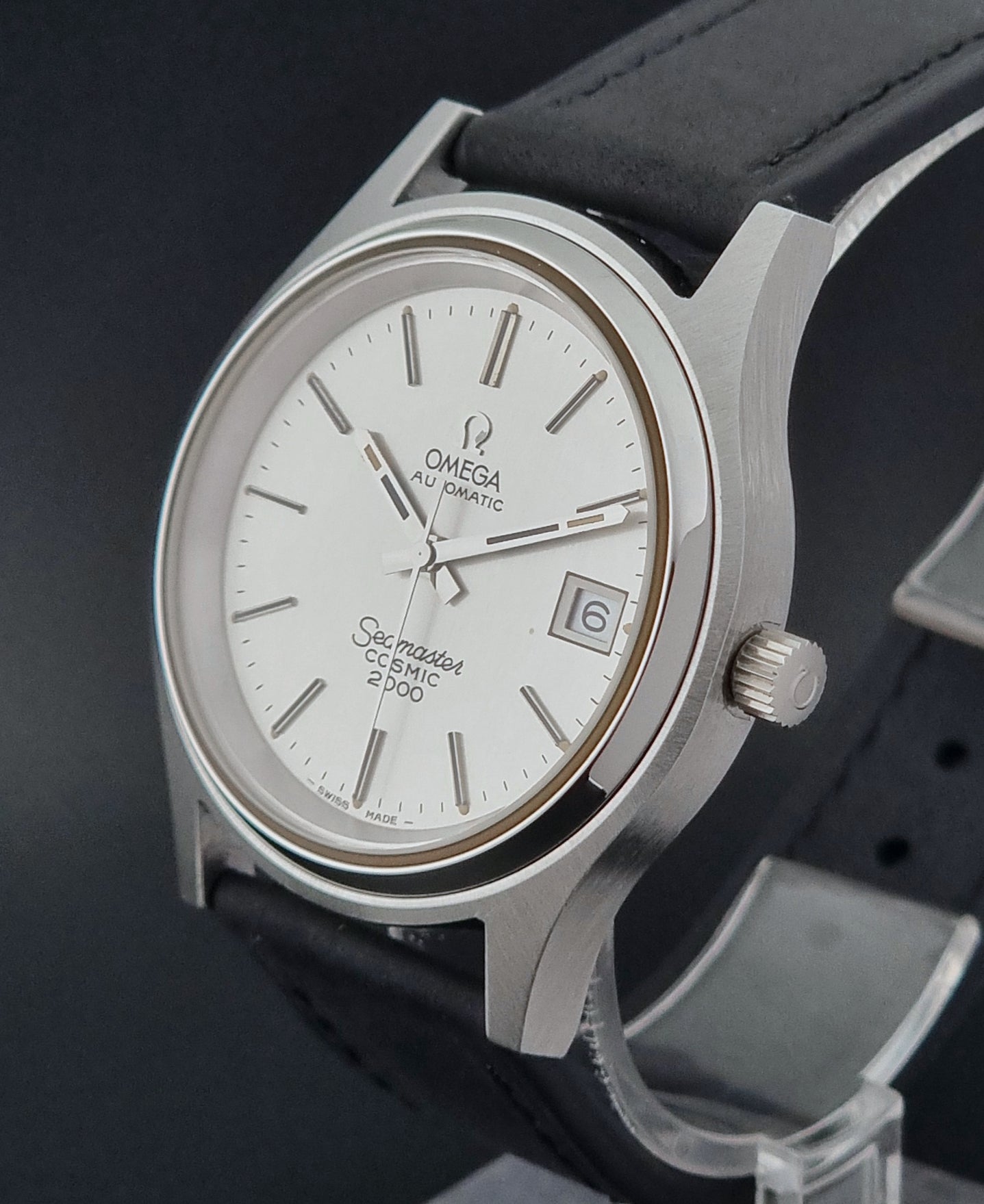 Vintage Omega Wristwatch Seamaster Cosmic 2000 Jumbo 166.128 watch with black leather strap on a dark surface close crown profile view