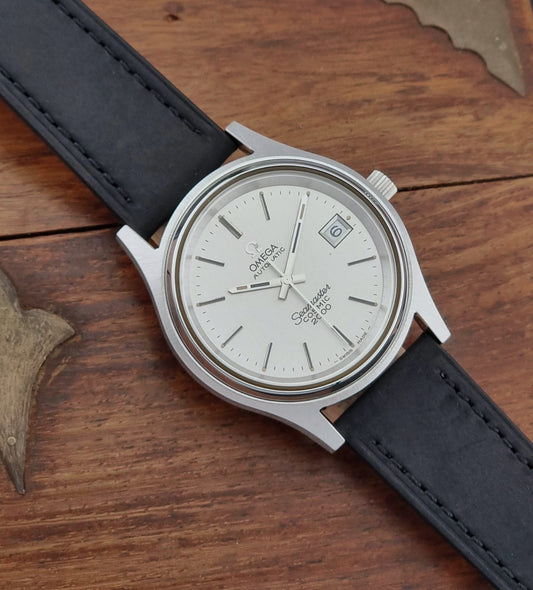 Vintage Omega Wristwatch Seamaster Cosmic 2000 Jumbo 166.128 watch with black leather strap on a wooden surface