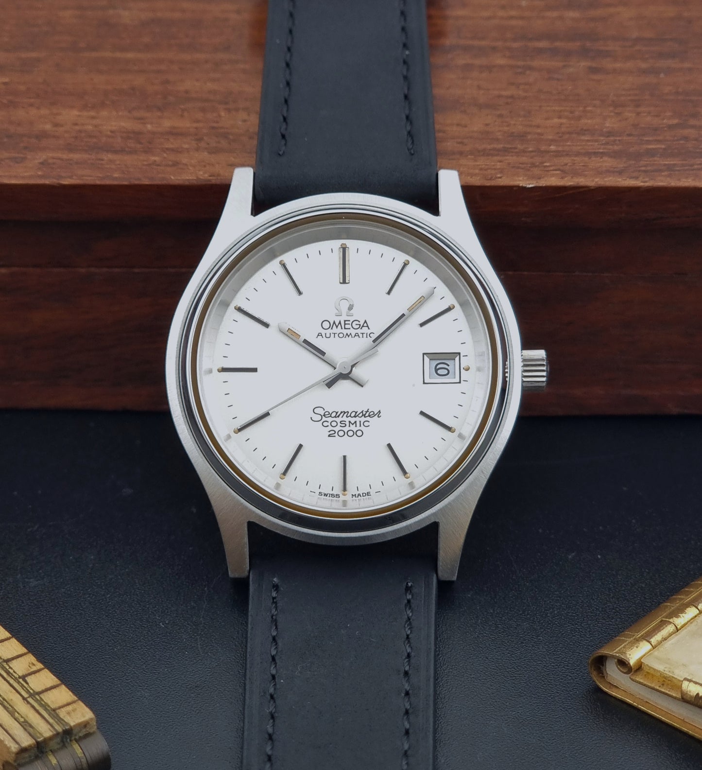 Vintage Omega Wristwatch Seamaster Cosmic 2000 Jumbo 166.128 watch with black leather strap on a wooden surface front