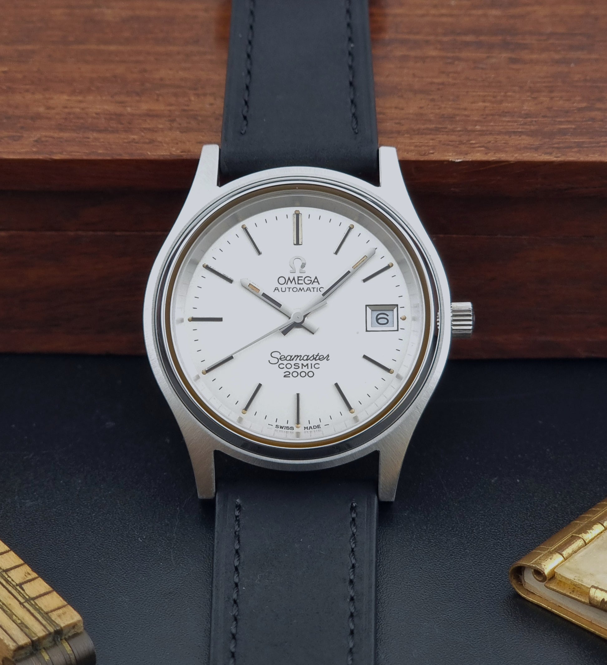 Vintage Omega Wristwatch Seamaster Cosmic 2000 Jumbo 166.128 watch with black leather strap on a wooden surface front