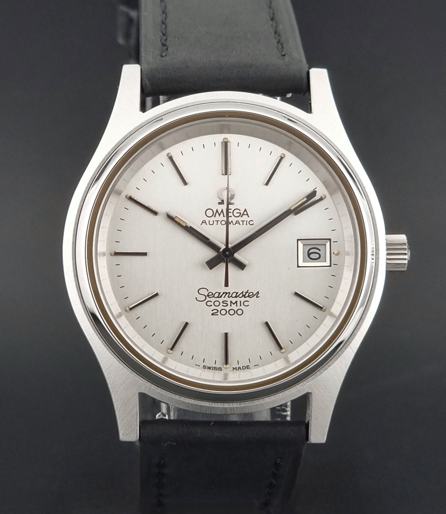 Vintage Omega Wristwatch Seamaster Cosmic 2000 Jumbo 166.128 watch with black leather strap on a wooden surface close front view