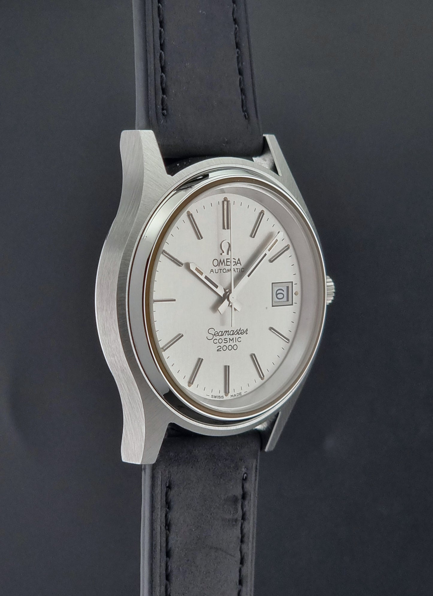 Vintage Omega Wristwatch Seamaster Cosmic 2000 Jumbo 166.128 watch with black leather strap on a dark surface side profile view