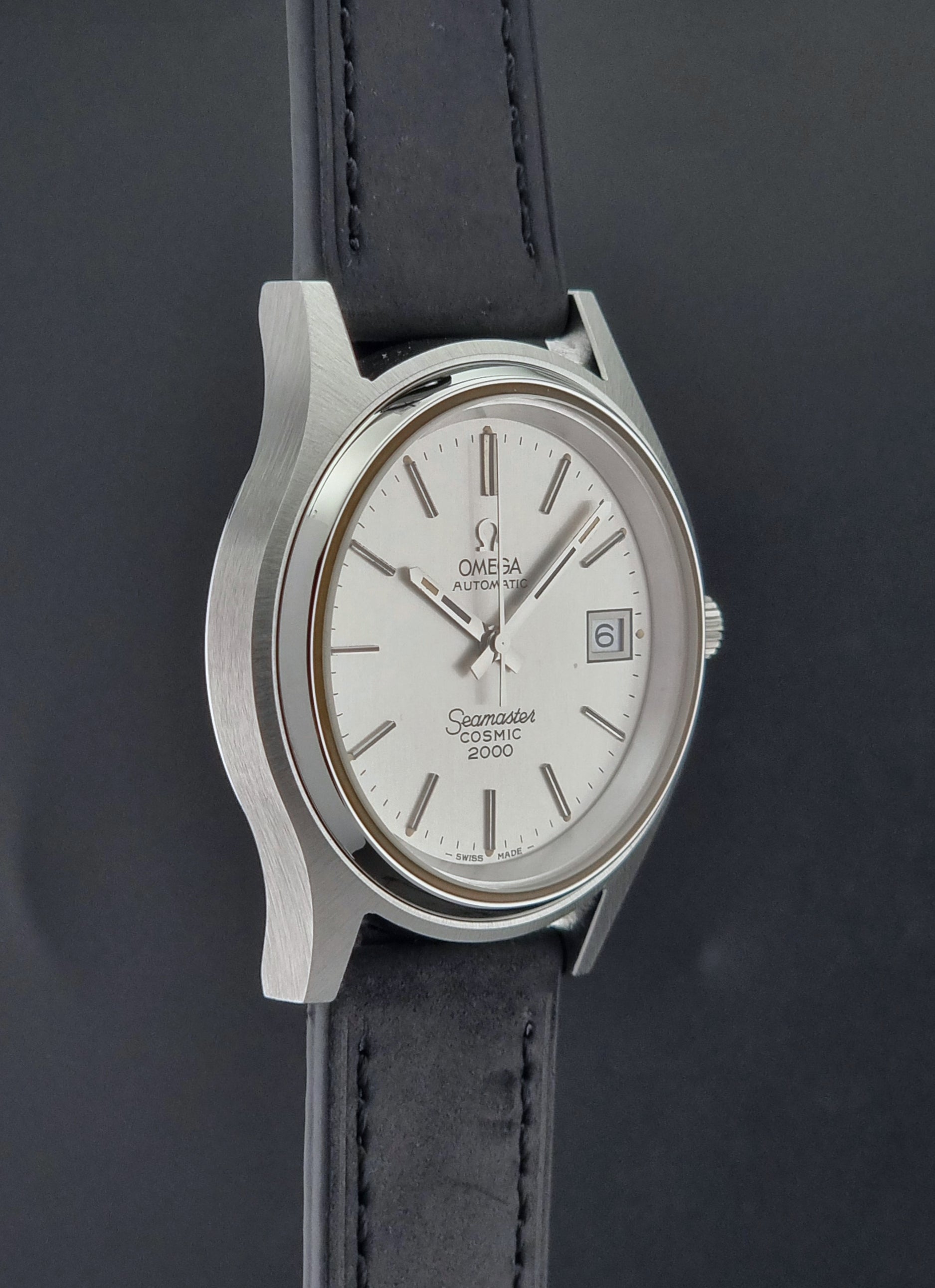 Vintage Omega Wristwatch Seamaster Cosmic 2000 Jumbo 166.128 watch with black leather strap on a dark surface side profile view
