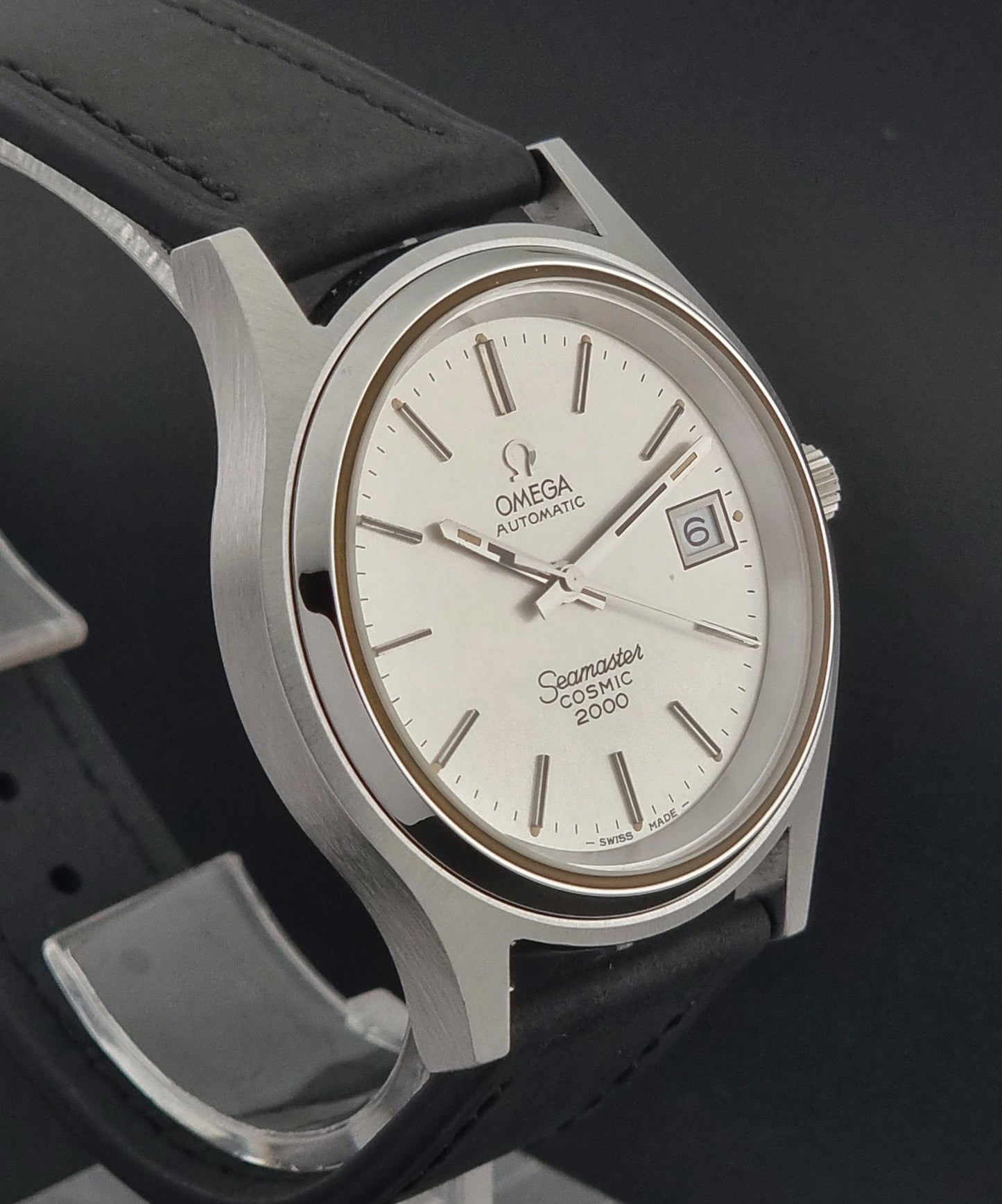 Vintage Omega Wristwatch Seamaster Cosmic 2000 Jumbo 166.128 watch with black leather strap on a dark surface close side profile view