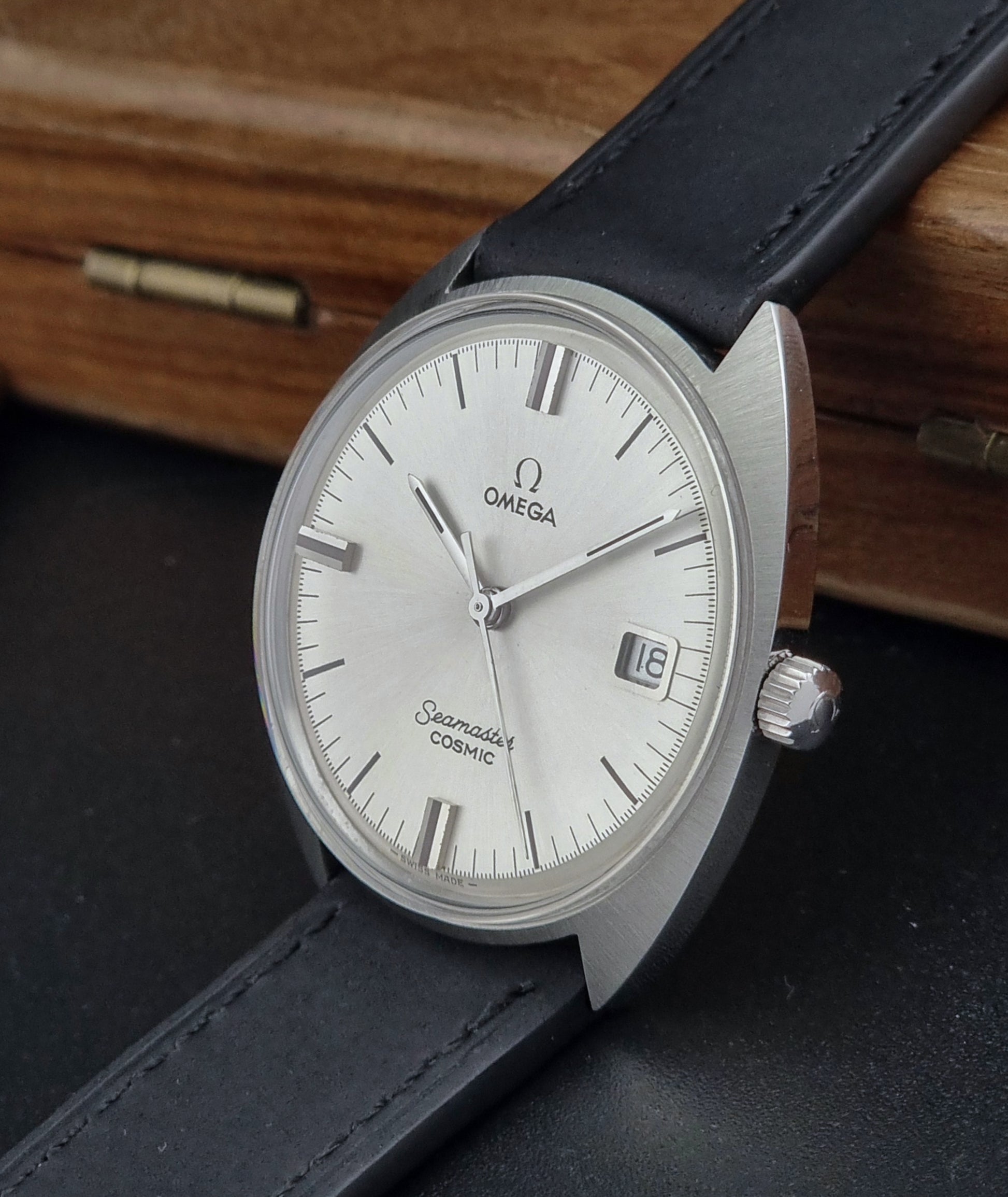 Omega Seamaster Cosmic 136.017 watch with black strap on a dark surface