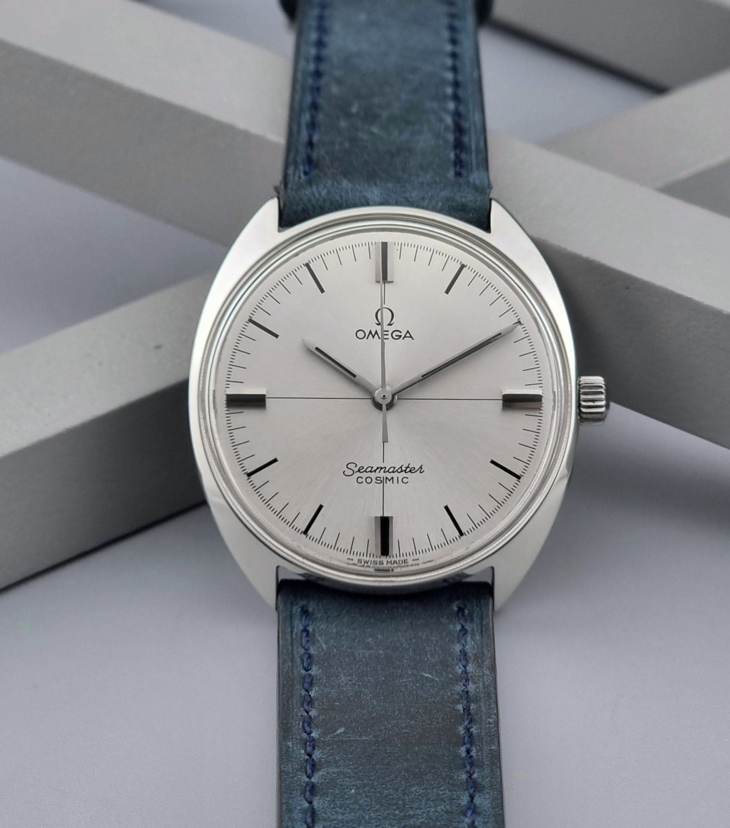 Vintage Omega Wristwatch Seamaster Cosmic 135.017 with blue leather strap on a gray background front view