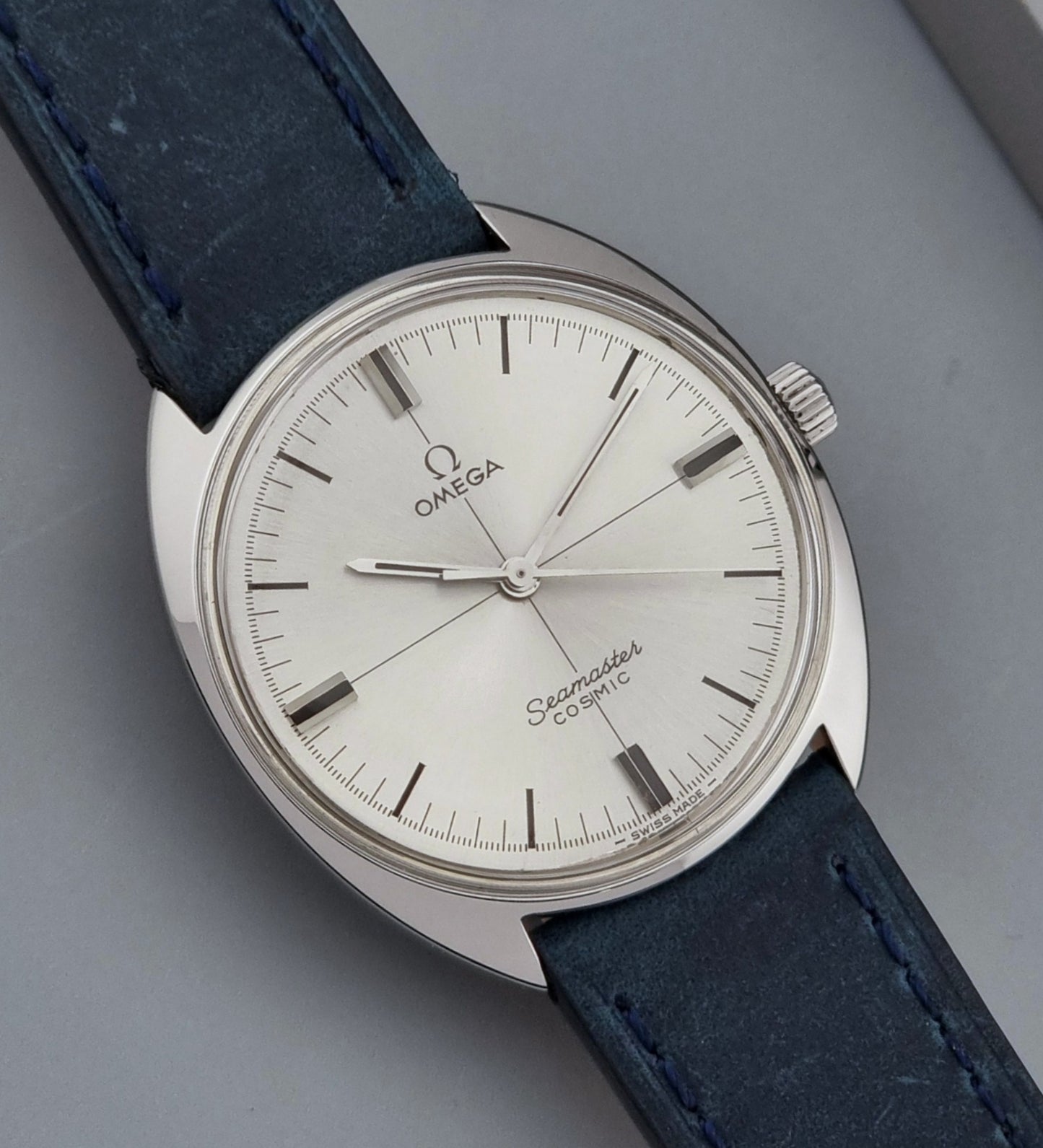 Vintage Omega Wristwatch Seamaster Cosmic 135.017 with blue leather strap on a gray background dial view
