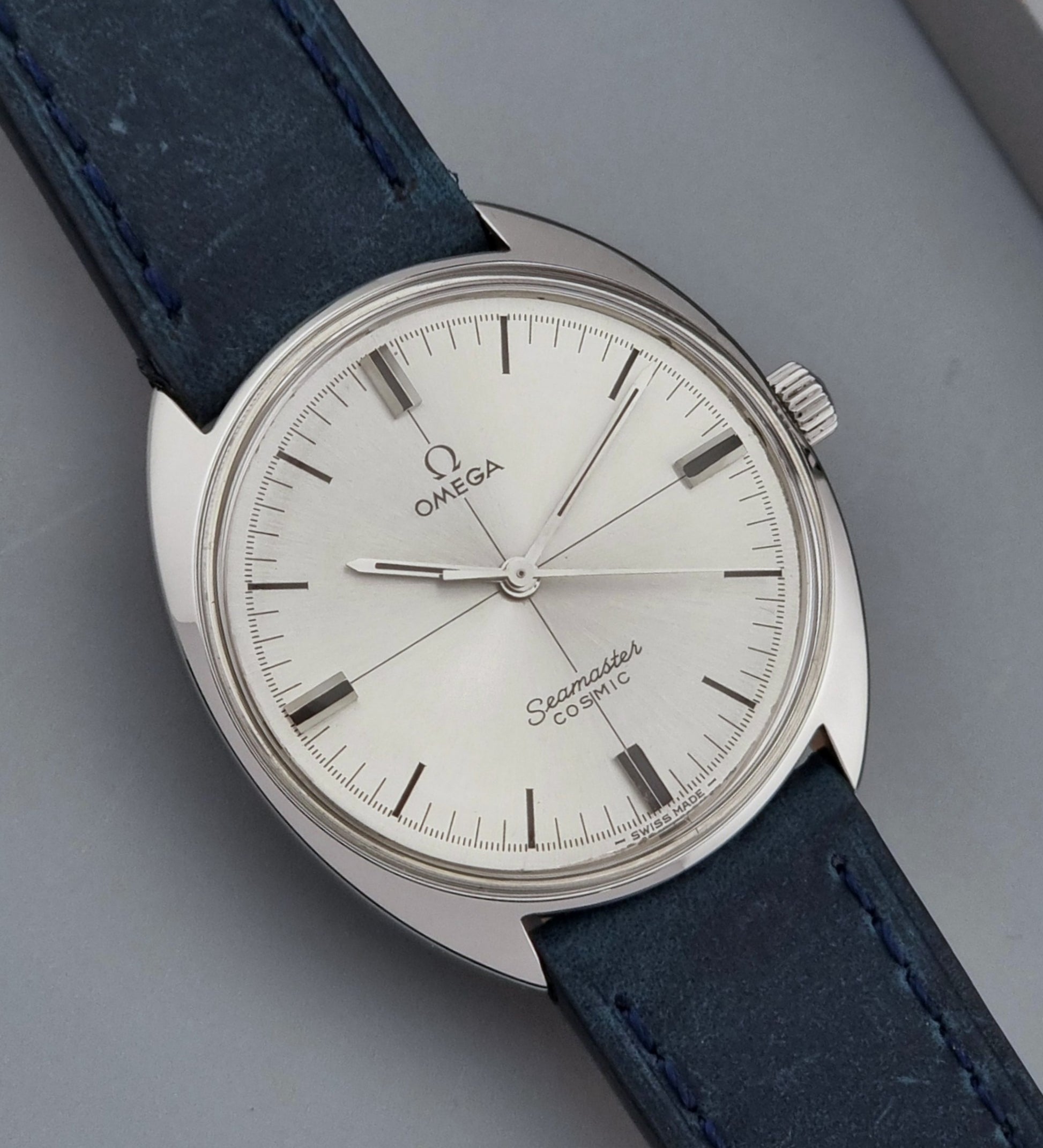 Vintage Omega Wristwatch Seamaster Cosmic 135.017 with blue leather strap on a gray background dial view