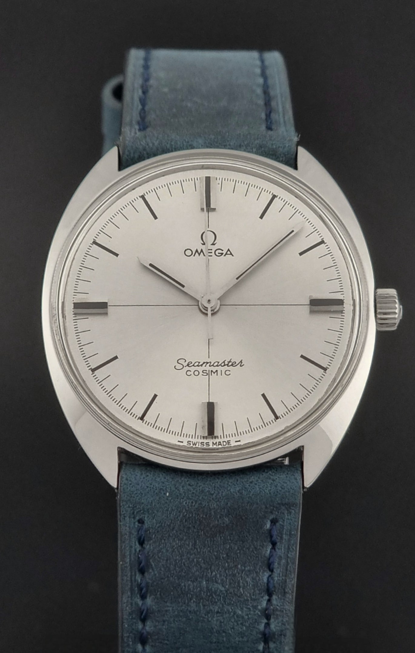 Vintage Omega Wristwatch Seamaster Cosmic 135.017 with blue leather strap on a gray background close front view