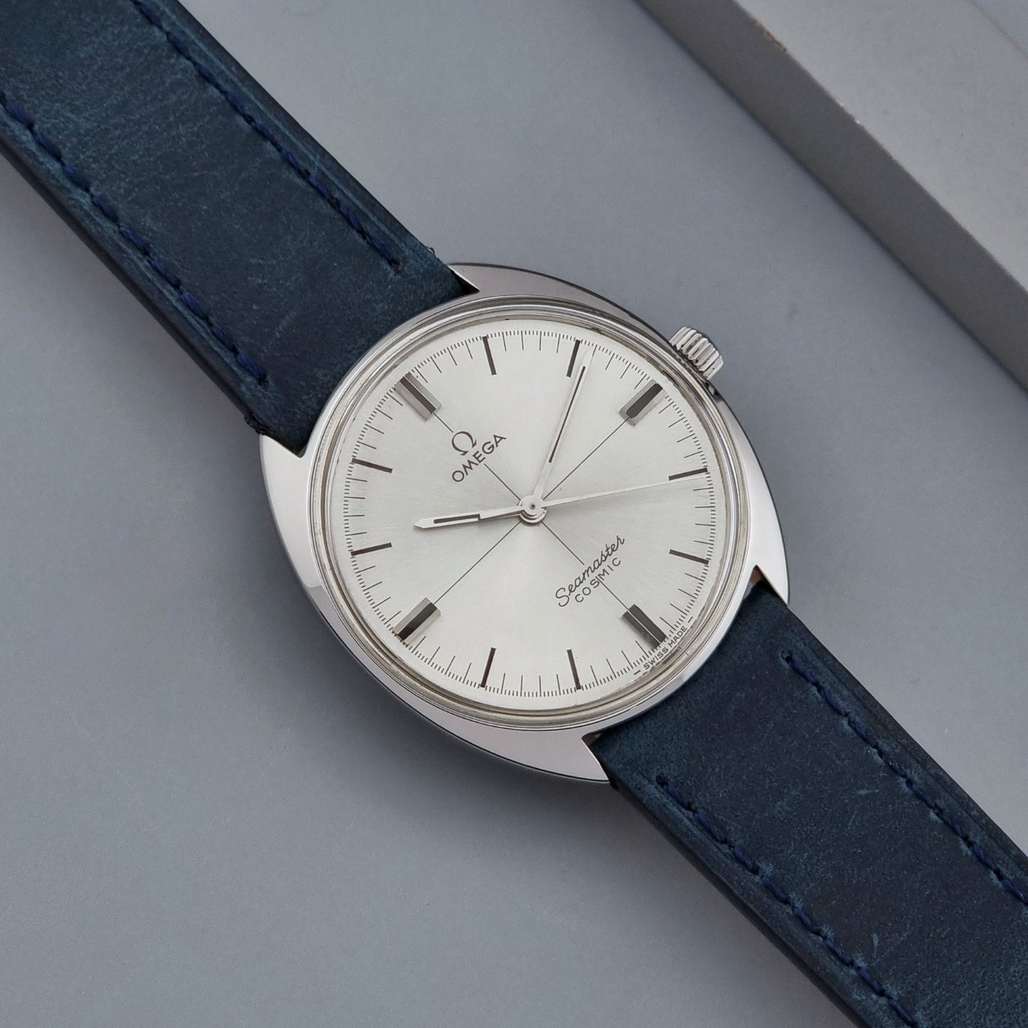 Vintage Omega Wristwatch Seamaster Cosmic 135.017 with blue leather strap on a gray background front