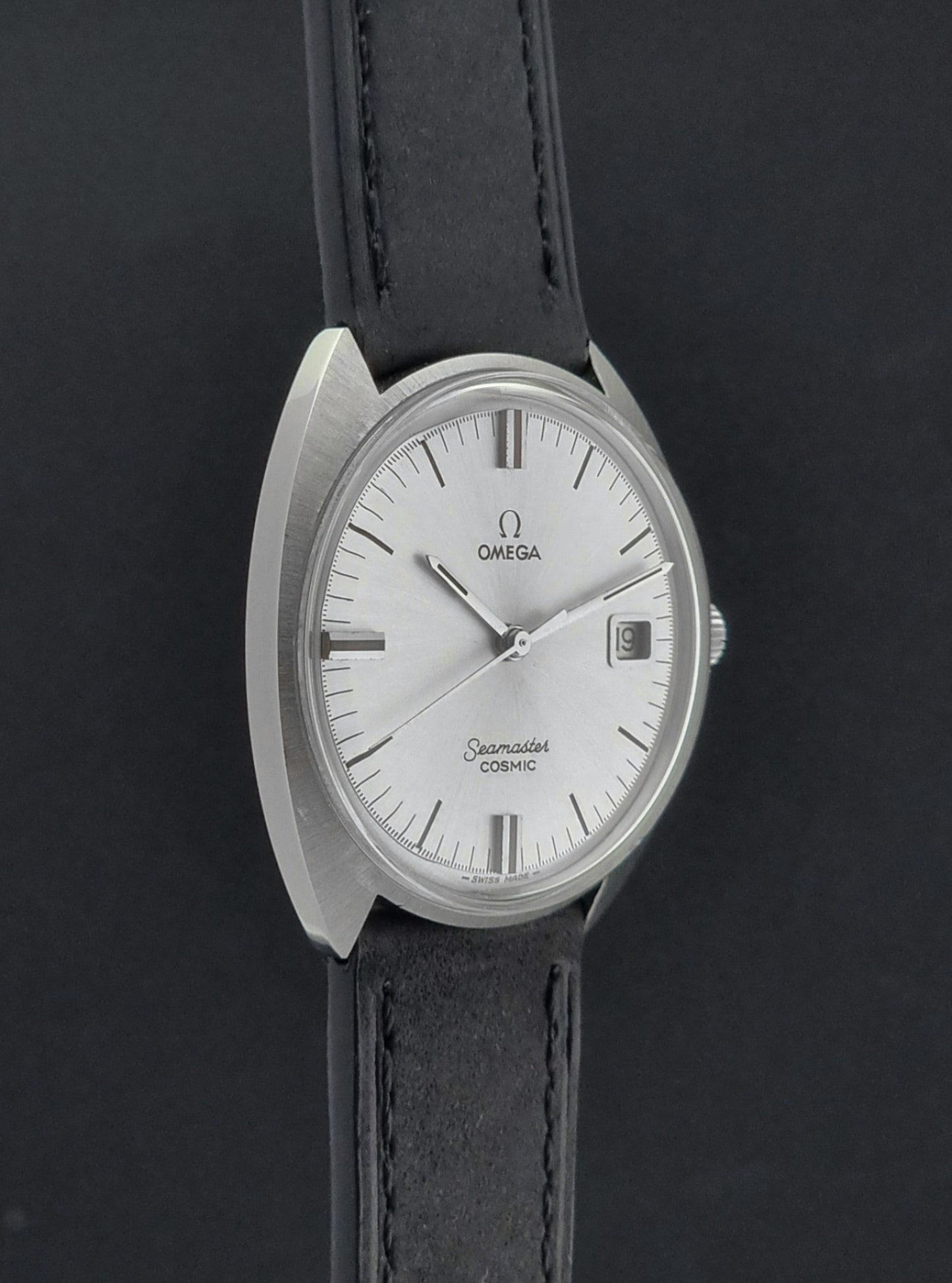 Omega Seamaster Cosmic 136.017 watch with black strap and silver dial on a dark background