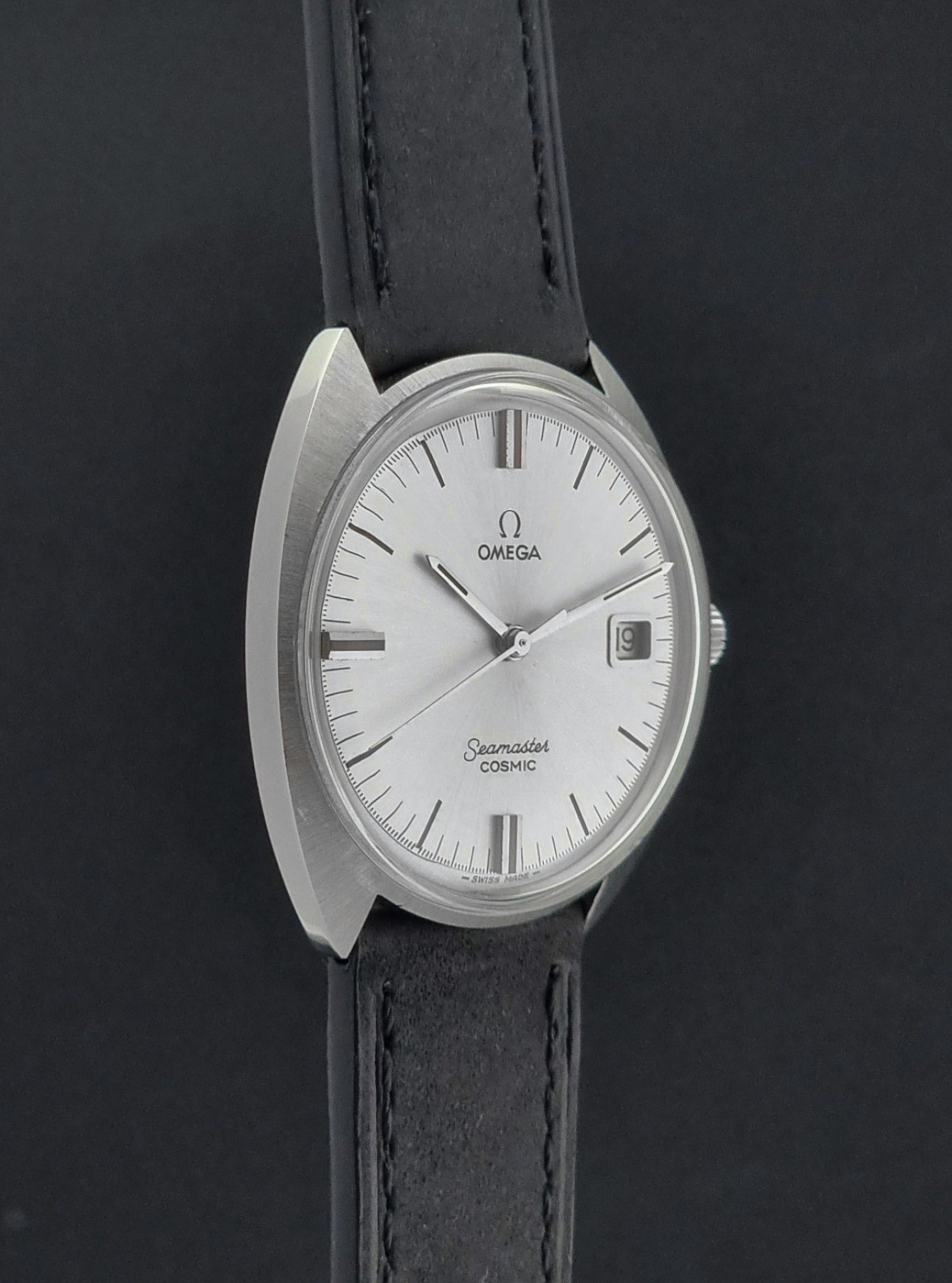 Omega Seamaster Cosmic 136.017 watch with black strap and silver dial on a dark background
