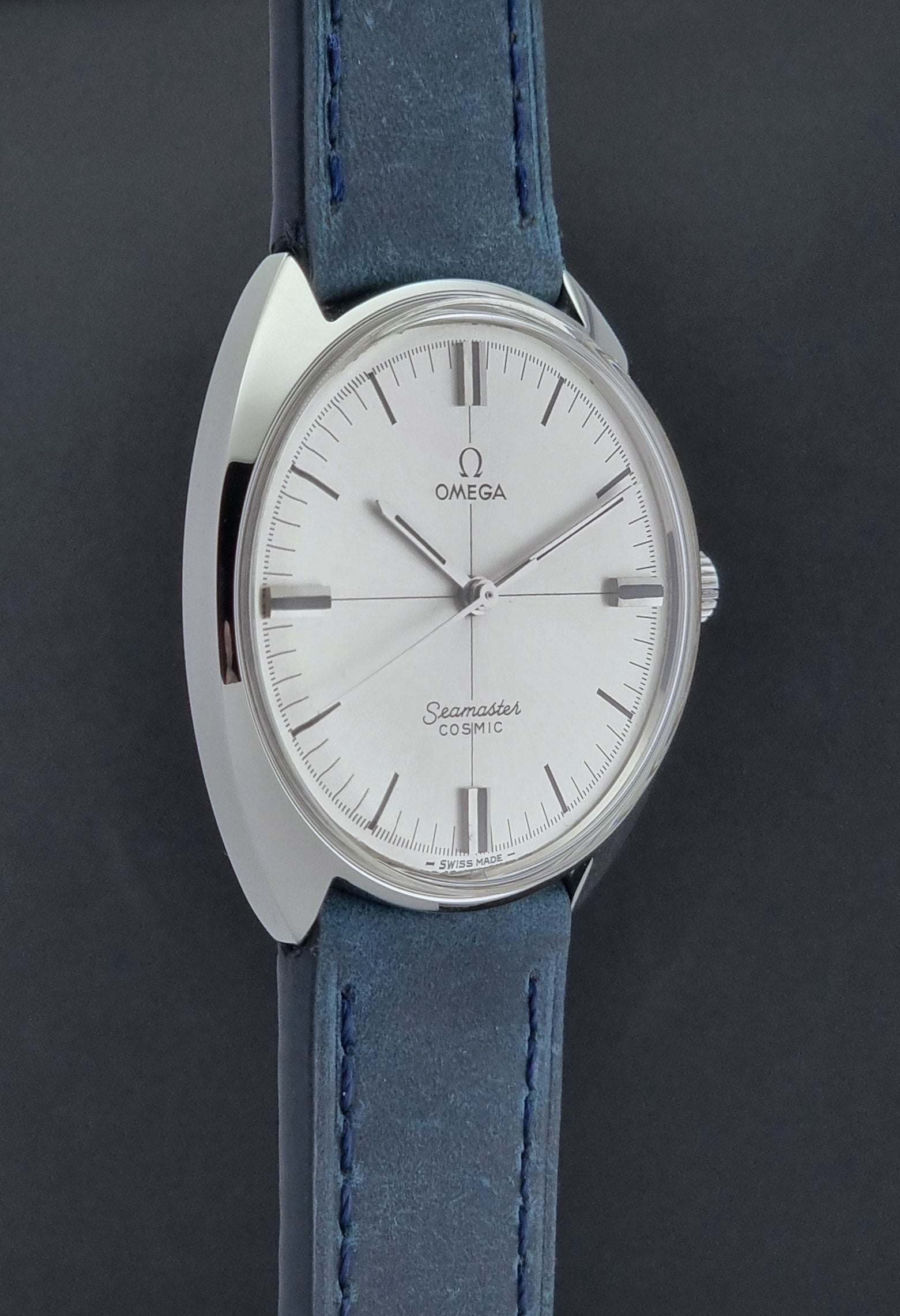 Vintage Omega Wristwatch Seamaster Cosmic 135.017 with blue leather strap on a gray background side profile