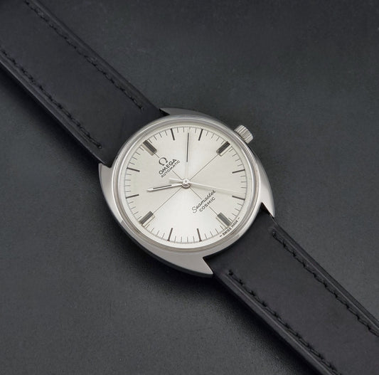 Vintage Omega Seamaster Cosmic Wristwatch 165.026 with a black leather strap on a dark background dial