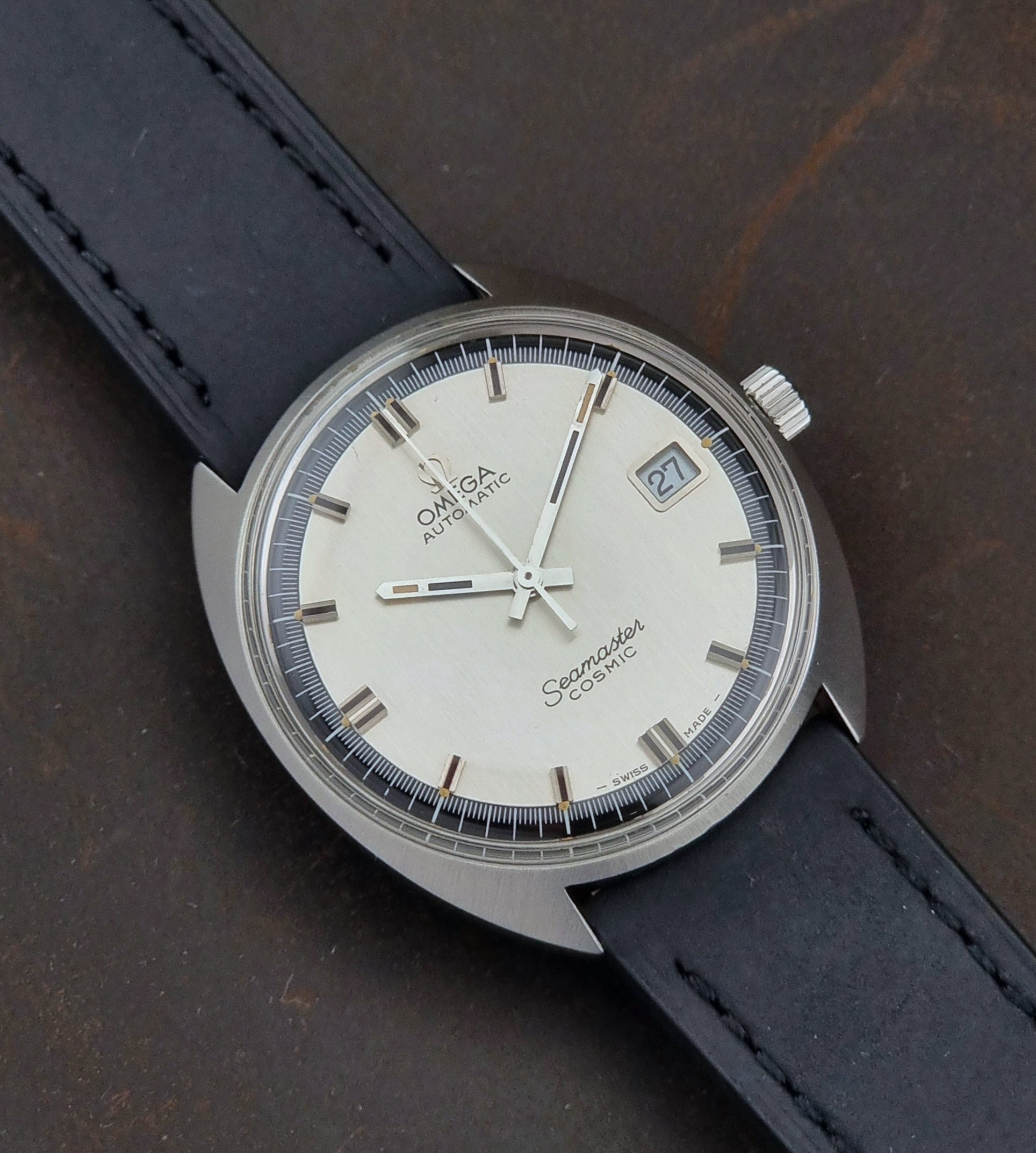 Vintage Omega Seamaster Cosmic  watch with a black strap on a dark surface