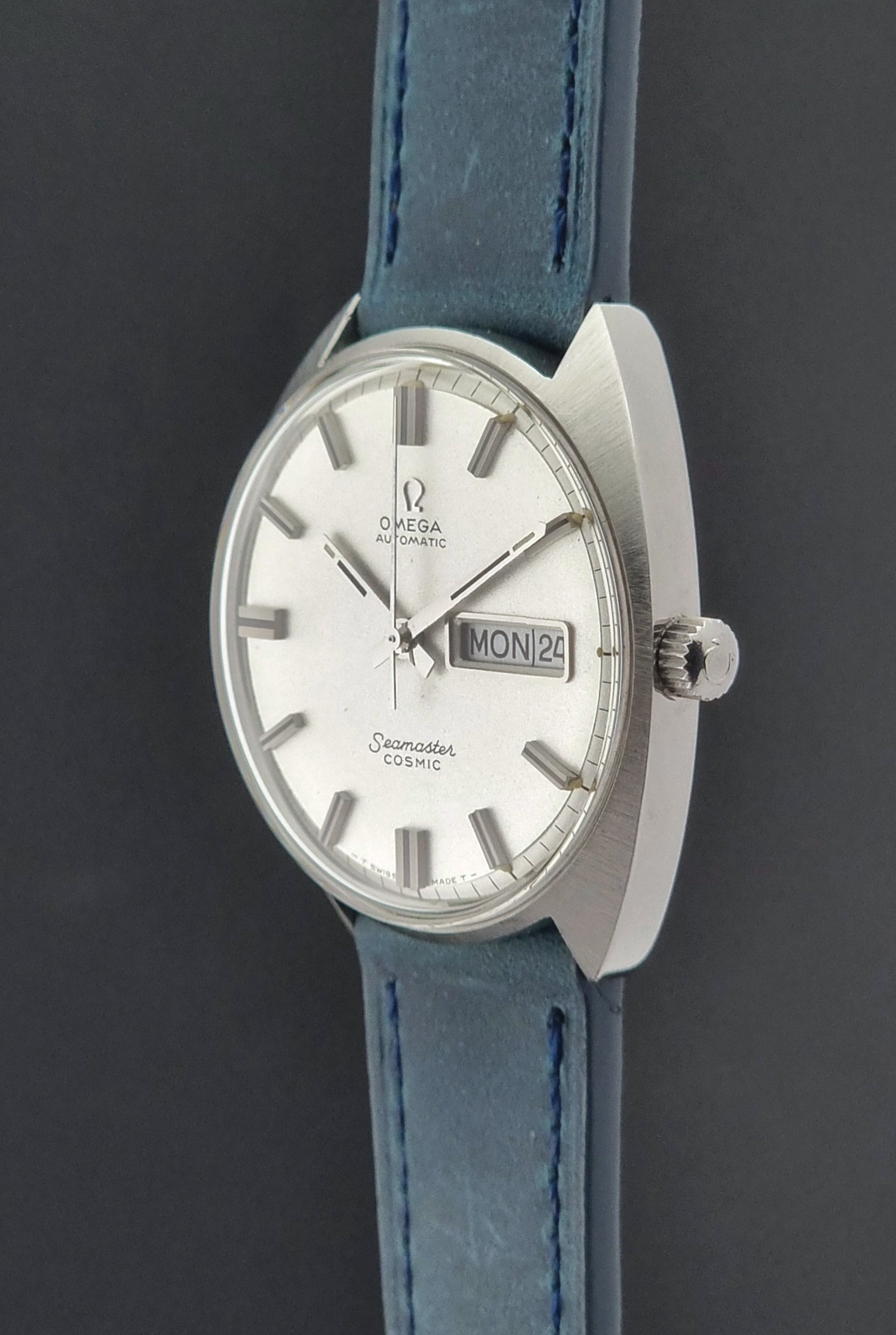 Vintage Omega Seamaster Cosmic with blue strap on a dark background