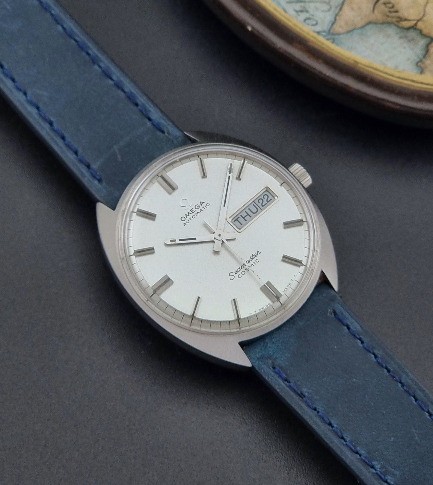 Vintage Omega Wristwatch 166.036 Seamaster Cosmic with blue leather strap on a dark surface front