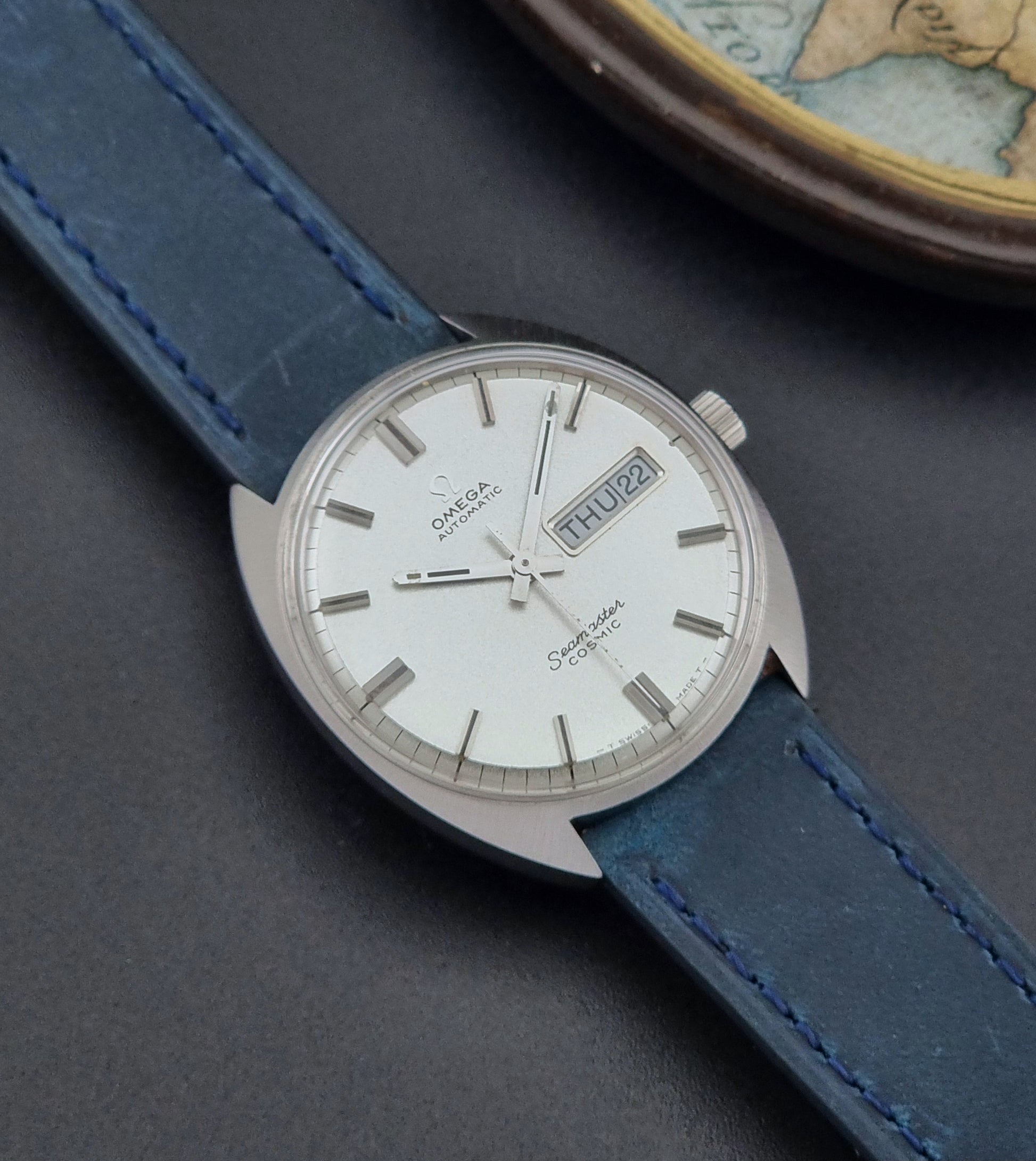 Vintage Omega Wristwatch 166.036 Seamaster Cosmic with blue leather strap on a dark surface front