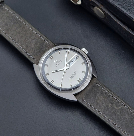 Vintage Omega Wristwatch 166.036 Seamaster Cosmic with grey leather strap on a dark background dial