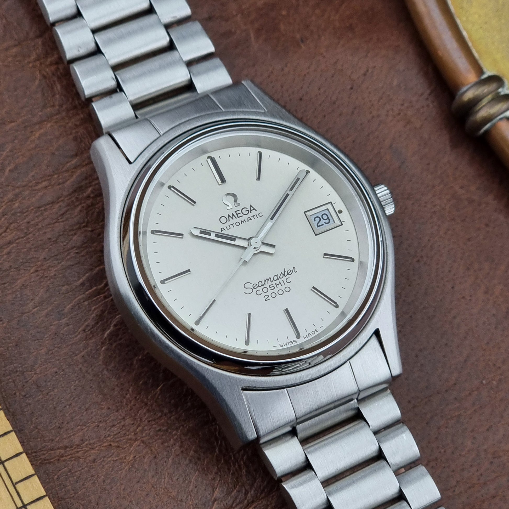Vintage Omega Seamaster watch on a brown leather surface