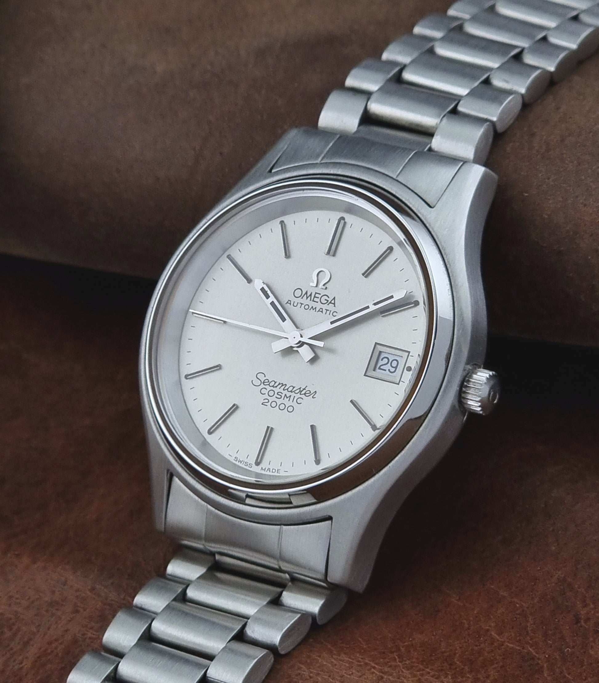Vintage Omega Seamaster watch on a brown leather background