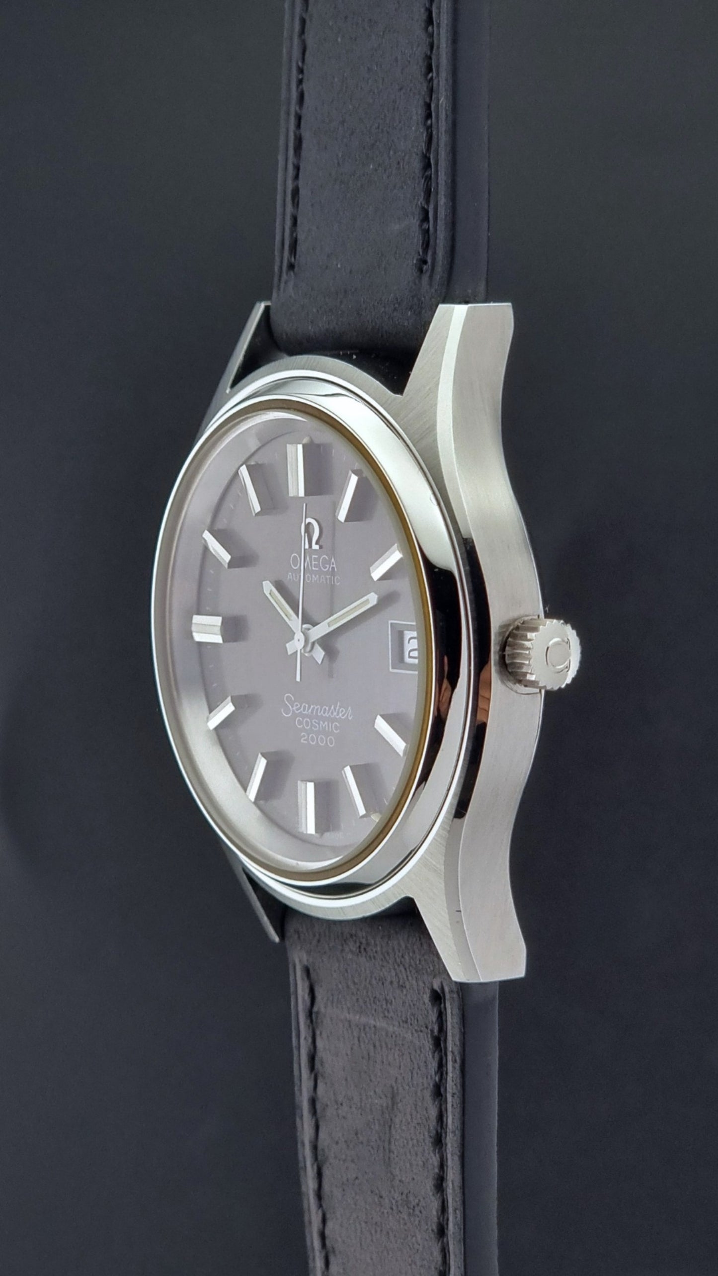 Vintage Omega Wristwatch Seamaster Cosmic 2000 Jumbo 166.128 black leather strap on a dark back ground crown profile view