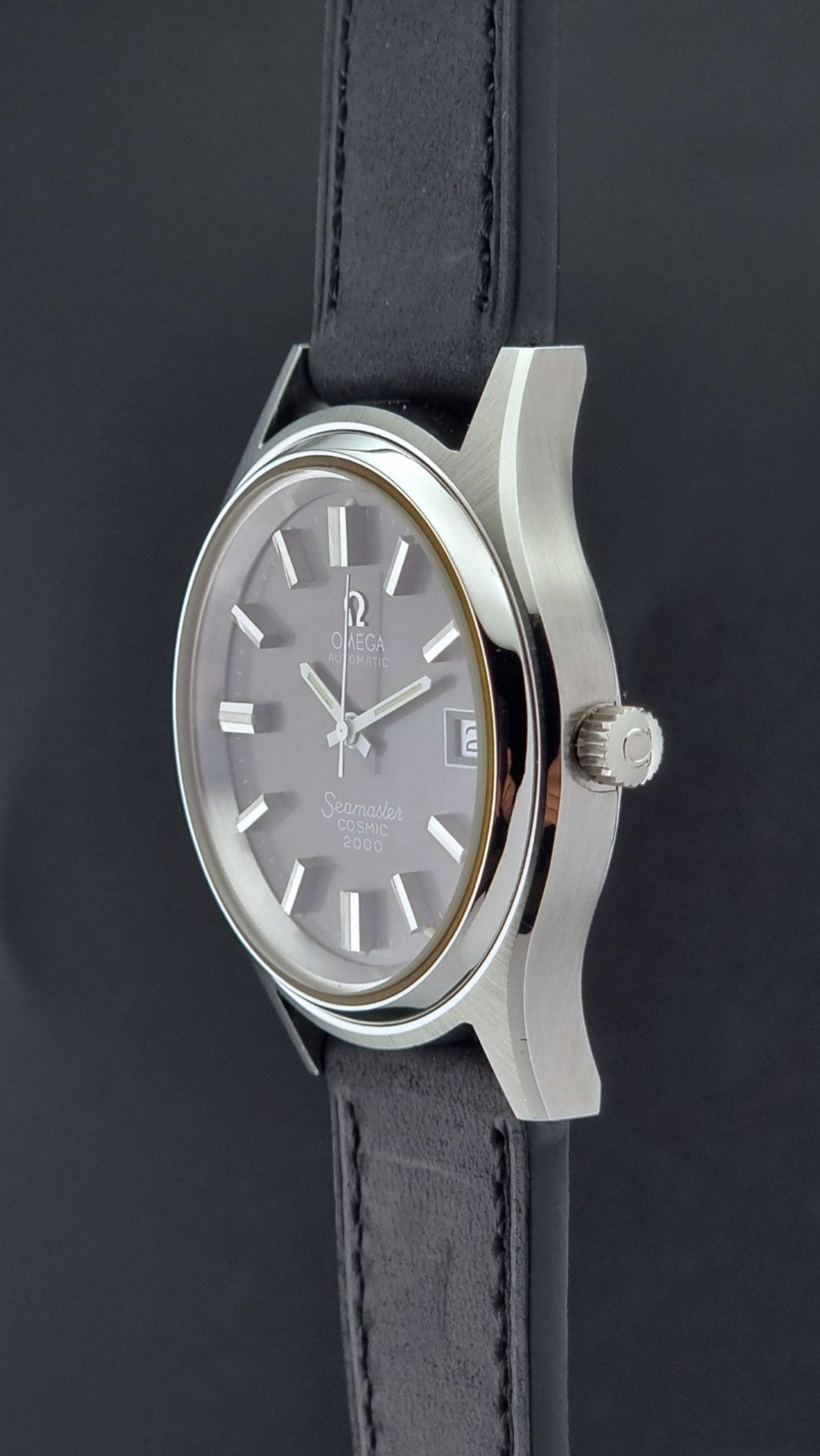 Vintage Omega Wristwatch Seamaster Cosmic 2000 Jumbo 166.128 black leather strap on a dark back ground crown profile view