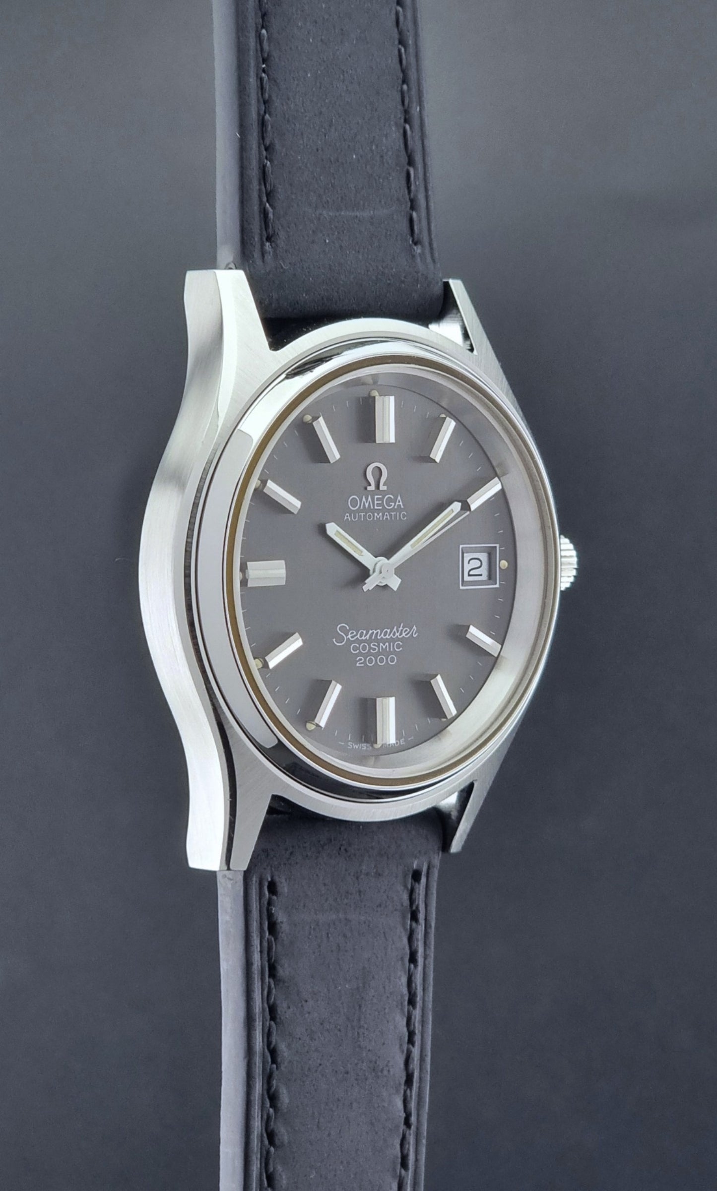 Vintage Omega Wristwatch Seamaster Cosmic 2000 Jumbo 166.128 black leather strap on a dark back ground side profile view