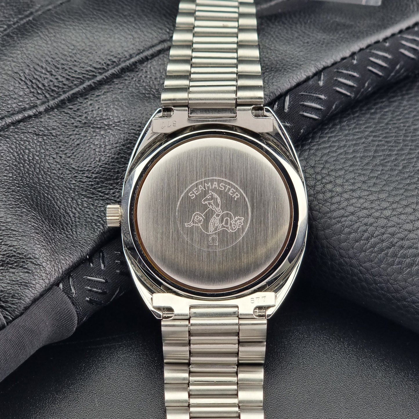 Vintage Omega Wristwatch Seamaster Cosmic 2000 Jumbo 166.130 watch with  stainless steel bracelet on a dark background case back view