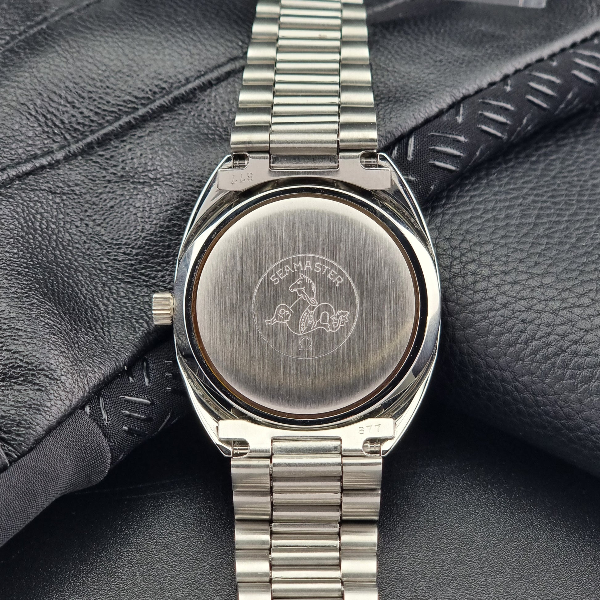 Vintage Omega Wristwatch Seamaster Cosmic 2000 Jumbo 166.130 watch with  stainless steel bracelet on a dark background case back view