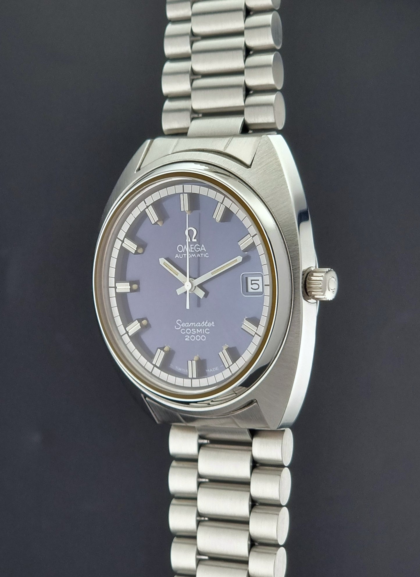 Vintage Omega Wristwatch Seamaster Cosmic 2000 Jumbo 166.130 watch with  stainless steel bracelet on a dark background crown profile view