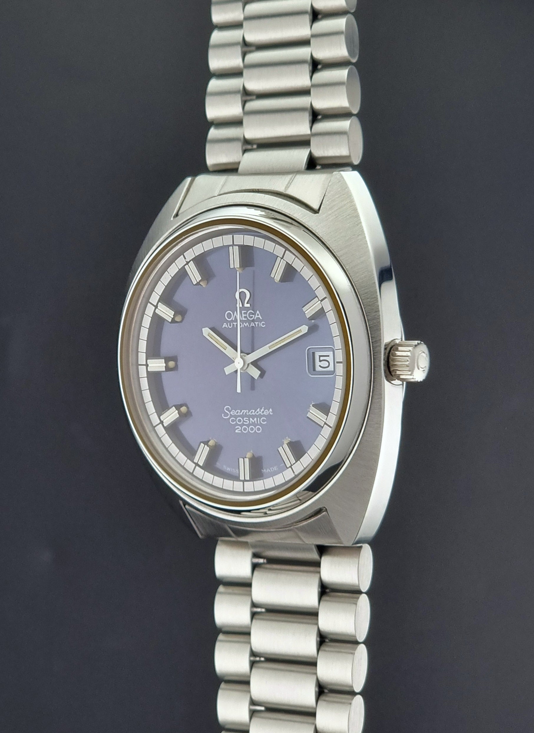 Vintage Omega Wristwatch Seamaster Cosmic 2000 Jumbo 166.130 watch with  stainless steel bracelet on a dark background crown profile view