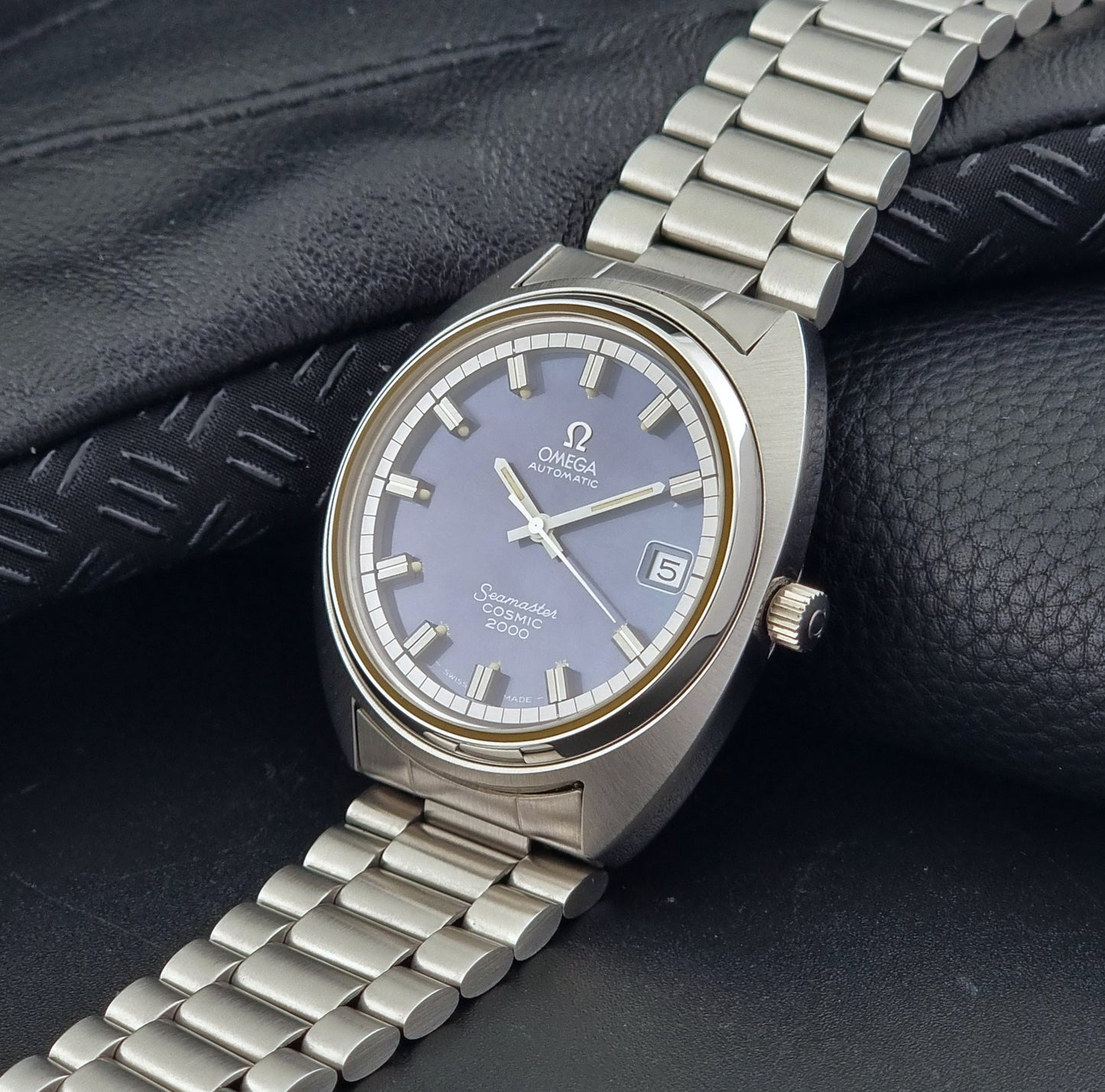 Vintage Omega Wristwatch Seamaster Cosmic 2000 Jumbo 166.130 watch with  stainless steel bracelet on a dark background crown view