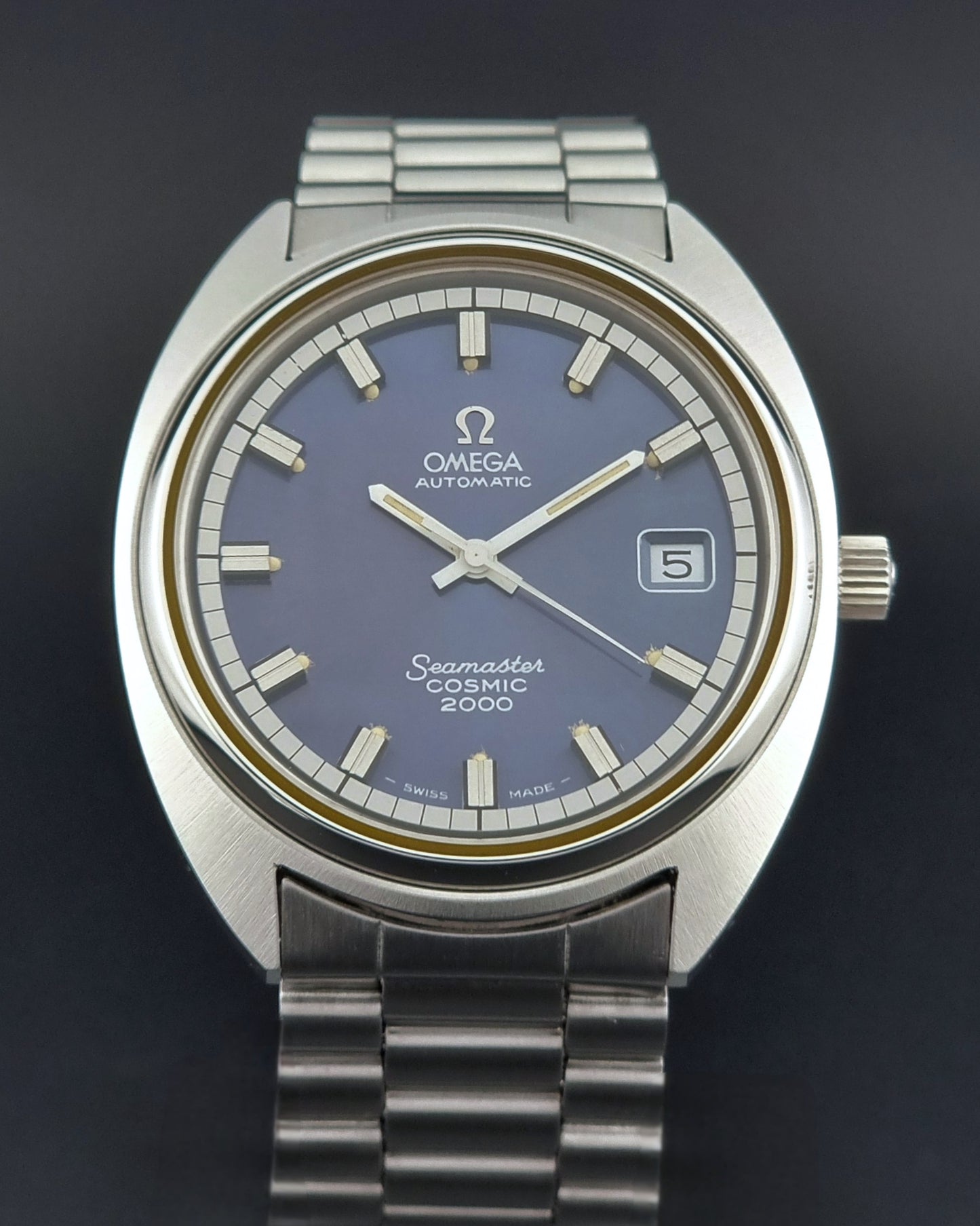 Vintage Omega Wristwatch Seamaster Cosmic 2000 Jumbo 166.130 watch with  stainless steel bracelet on a dark background close front view