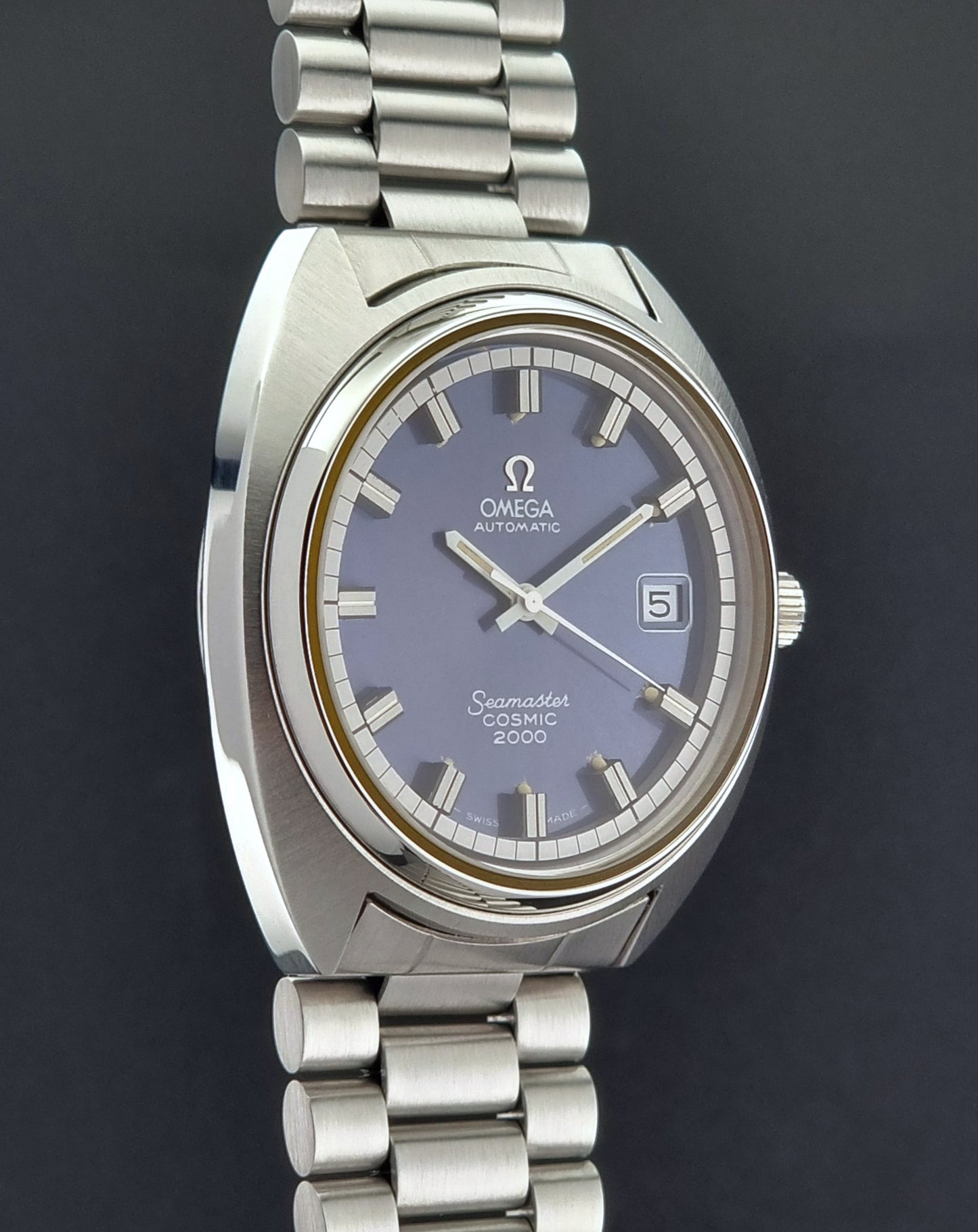 Vintage Omega Wristwatch Seamaster Cosmic 2000 Jumbo 166.130 watch with  stainless steel bracelet on a dark background side profile view