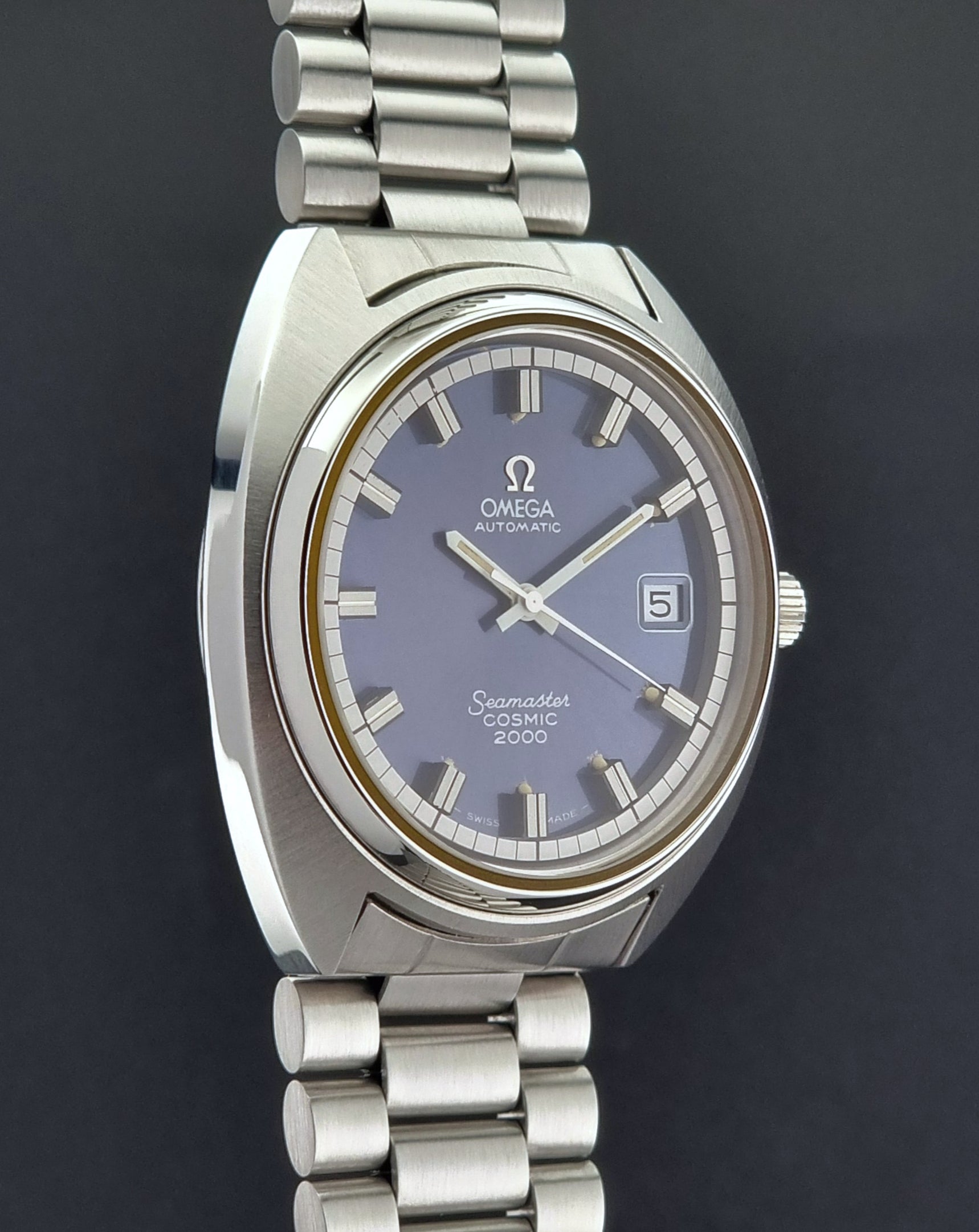 Vintage Omega Wristwatch Seamaster Cosmic 2000 Jumbo 166.130 watch with  stainless steel bracelet on a dark background side profile view