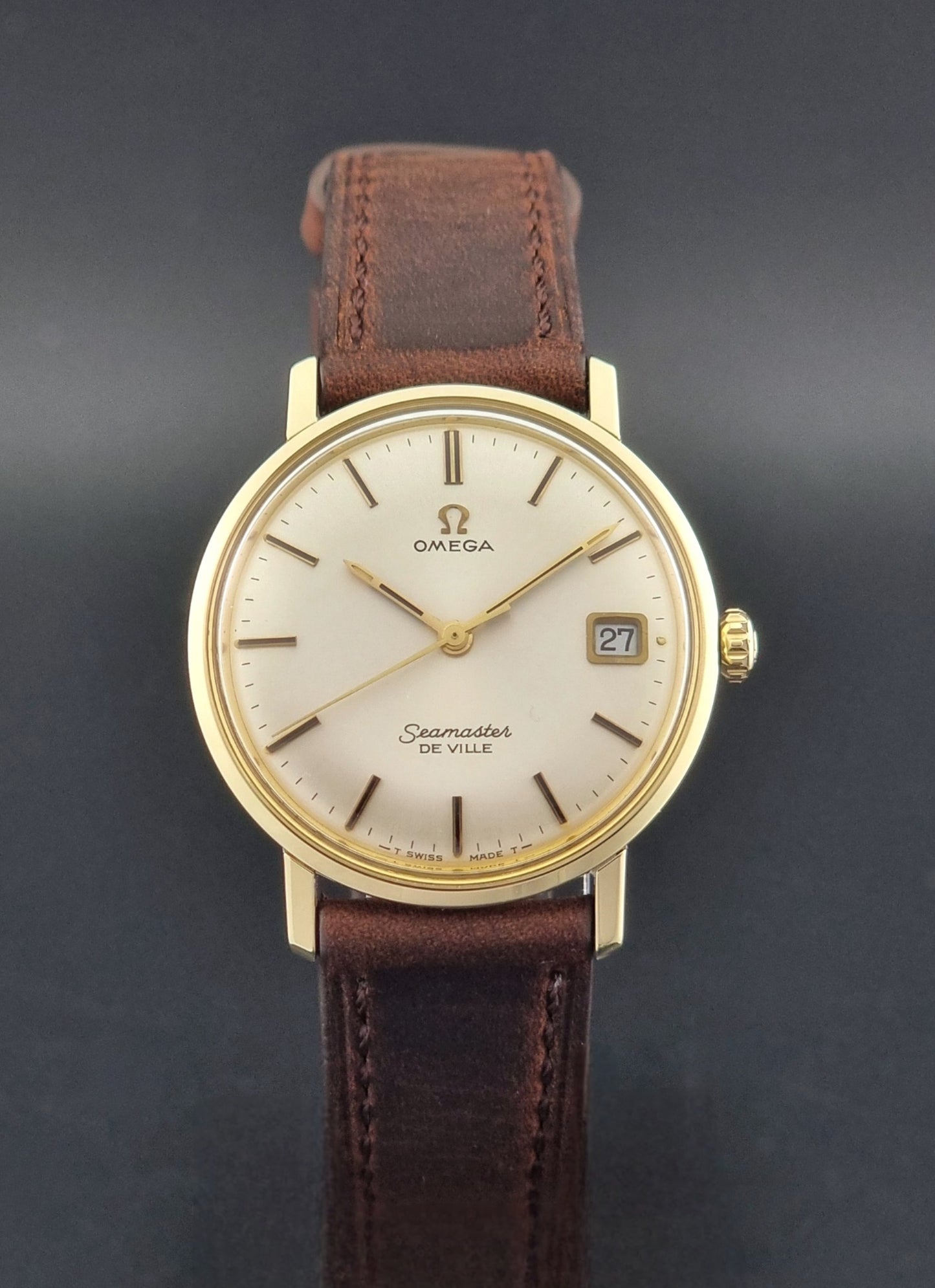 Vintage Omega Wristwatch Seamaster De-ville 136.020 gold capped with brown strap on a dark background close dial view