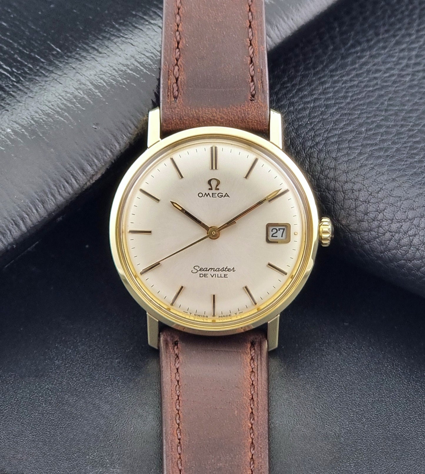 Vintage Omega Wristwatch Seamaster De-ville 136.020 gold capped with brown strap on a dark background dial view