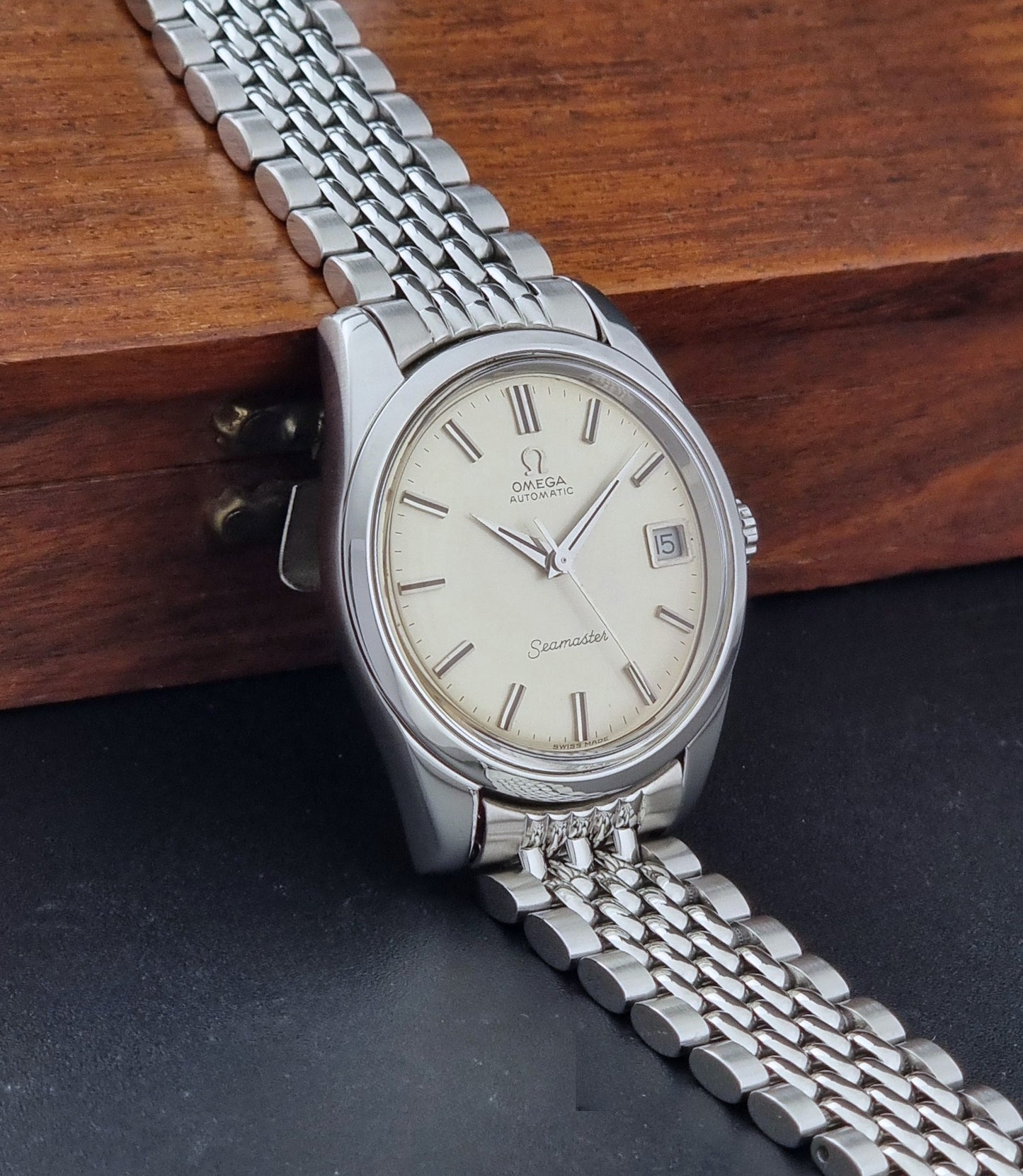 Vintage Omega Wristwatch Seamaster 166.010 with a detailed face on a dark background side view