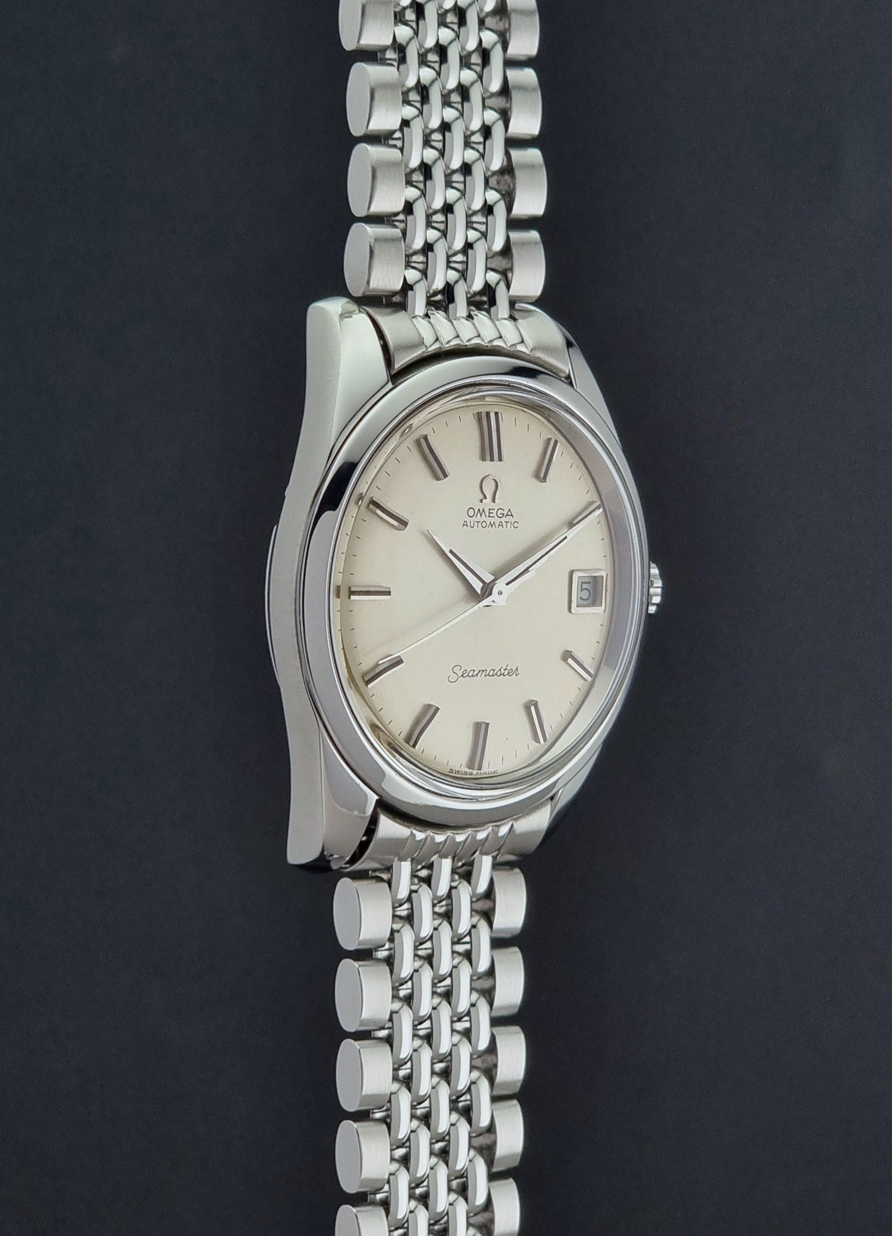 Vintage Omega Wristwatch Seamaster 166.010 with a detailed face on a dark background crown profile view