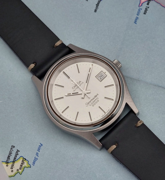 Omega Seamaster Cosmic 2000 166.128  watch with black leather strap on a light blue background