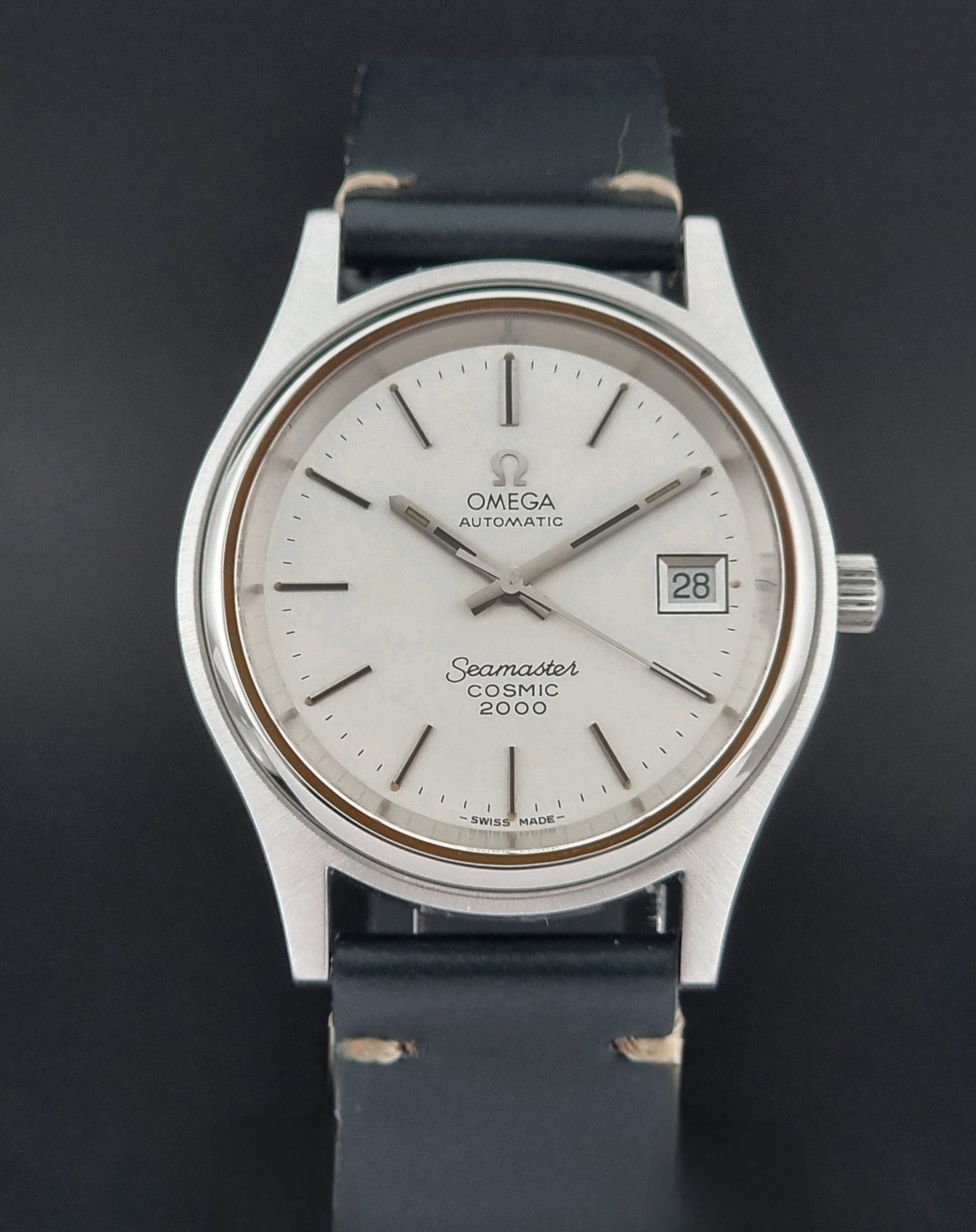 Omega Seamaster Cosmic 2000 166.128 watch with black leather strap on a dark background