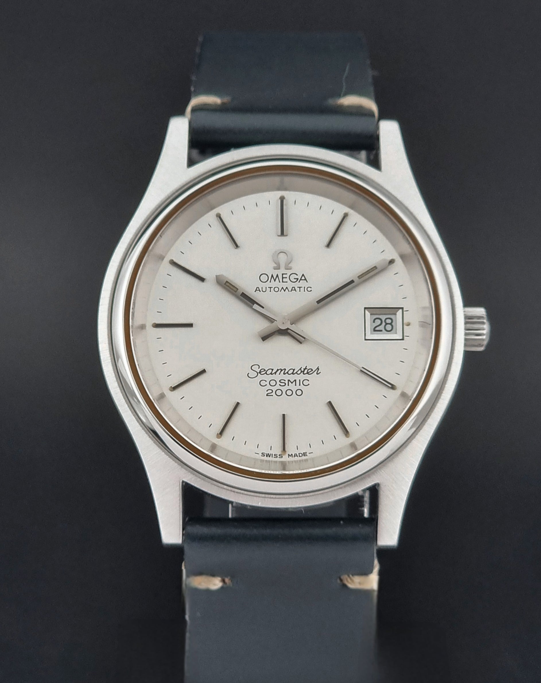 Omega Seamaster Cosmic 2000 166.128 watch with black leather strap on a dark background